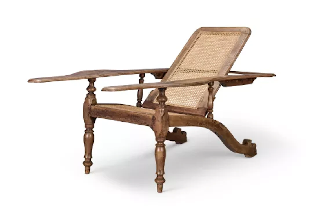 AN UNUSUAL NORTH INDIAN HARDWOOD AND CANED PLANTER'S CHAIR, CIRCA 1900
