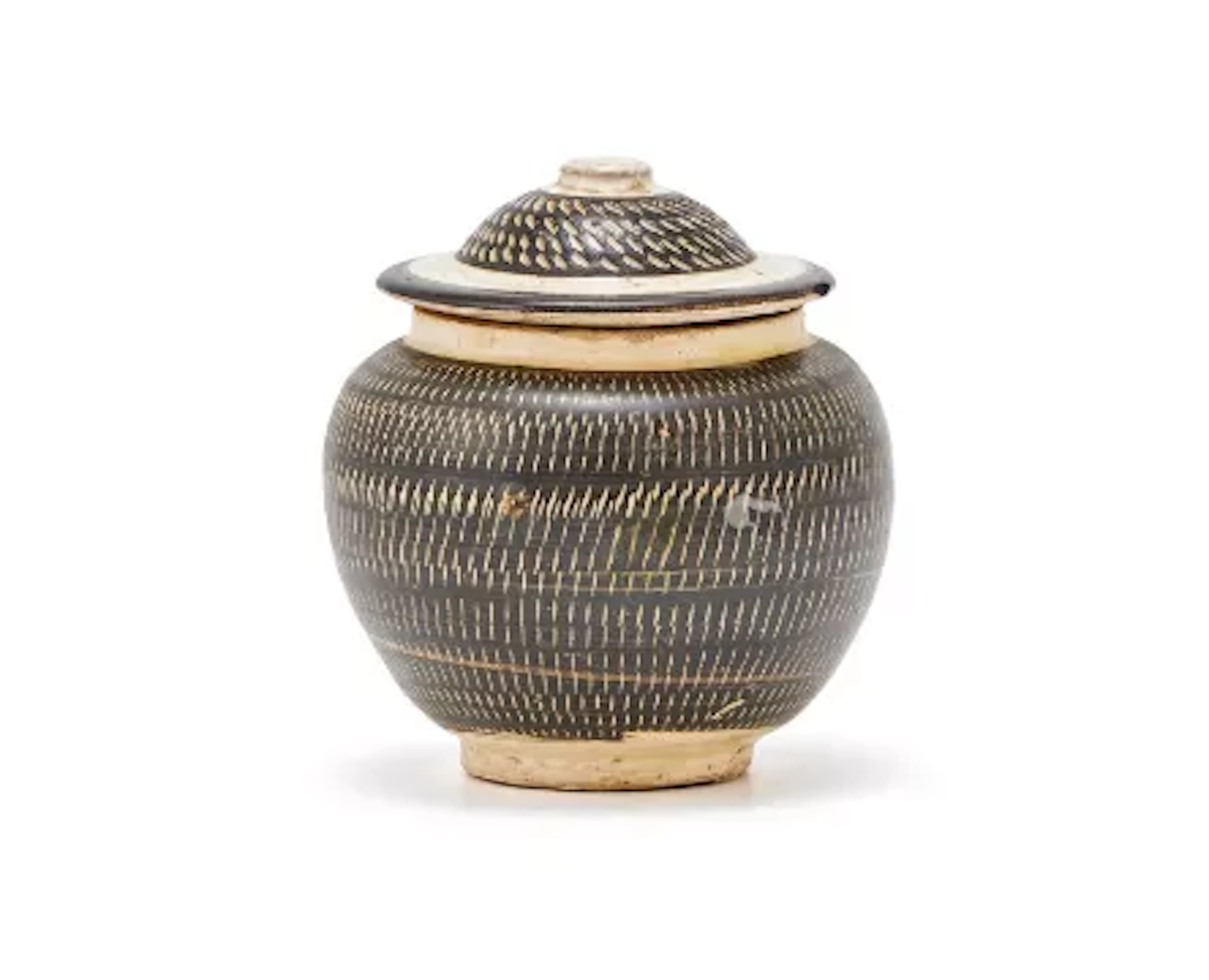 A Chinese Cizhou pottery jar and cover with rouletted decoration