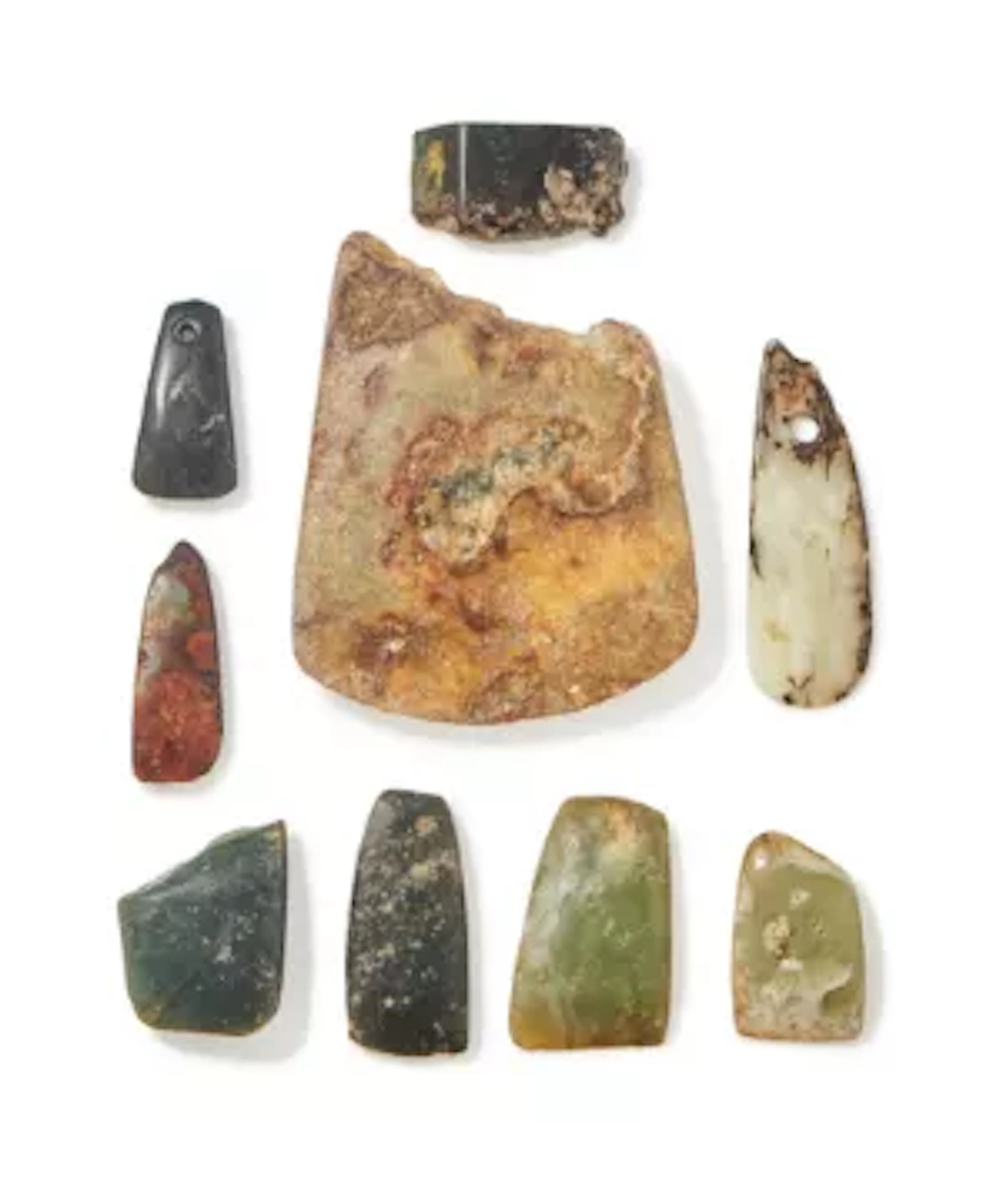 A group of nine carved jade and hardstone axes, Neolithic and later