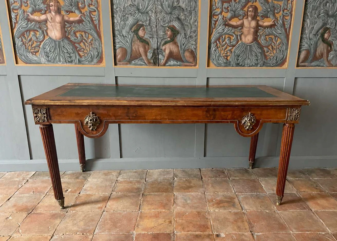 A pair of large, flat desks, veneered
