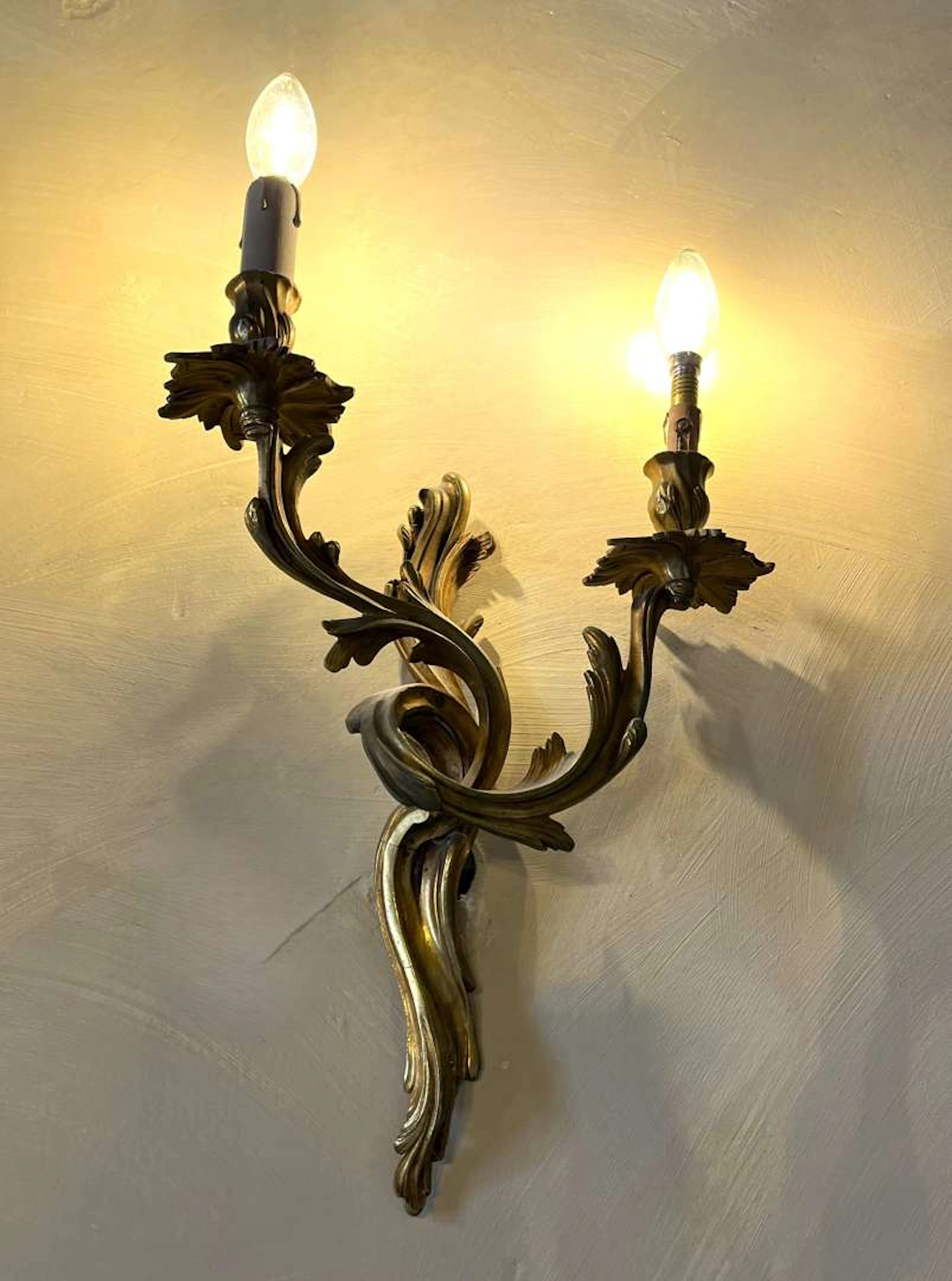 Pair of wall lights, in gilded bronze with two light arms