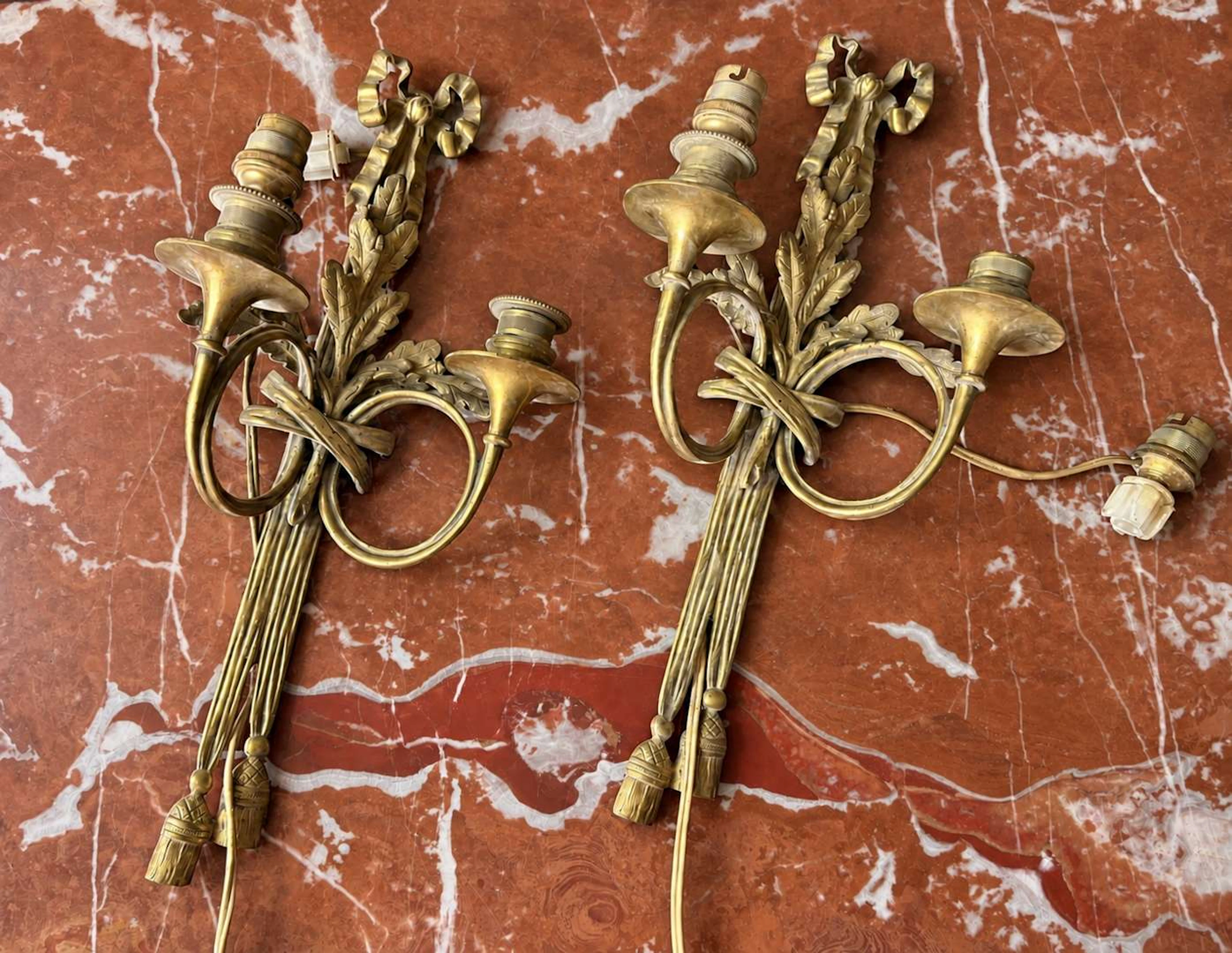 Pair of wall lights, with two gilded bronze light arms