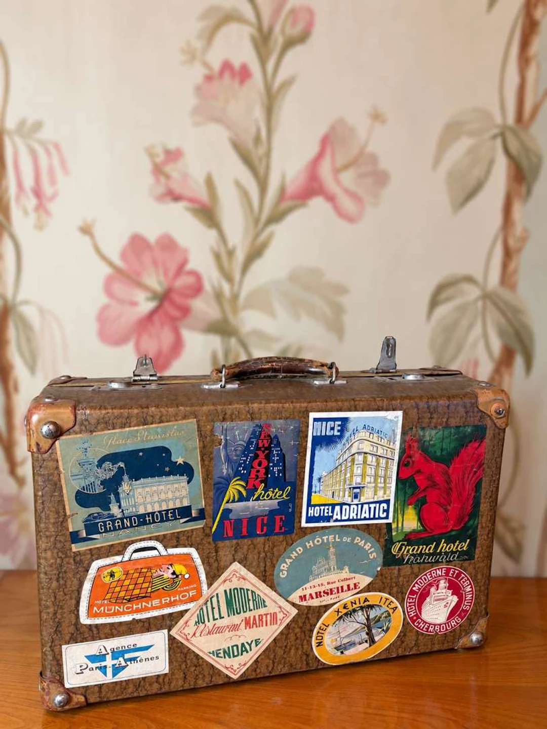 Antique suitcase, decorated with hotel and travel labels