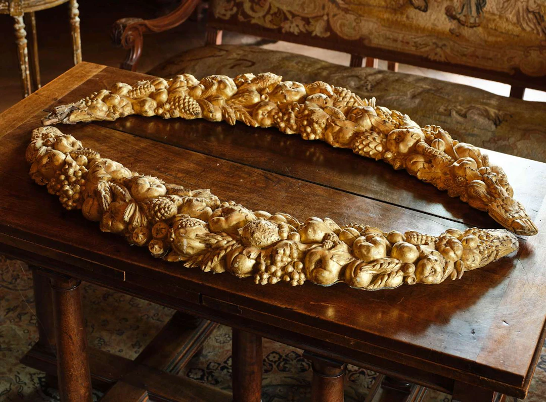 A pair of fruit garlands, made of gilded plaster on a wooden core
