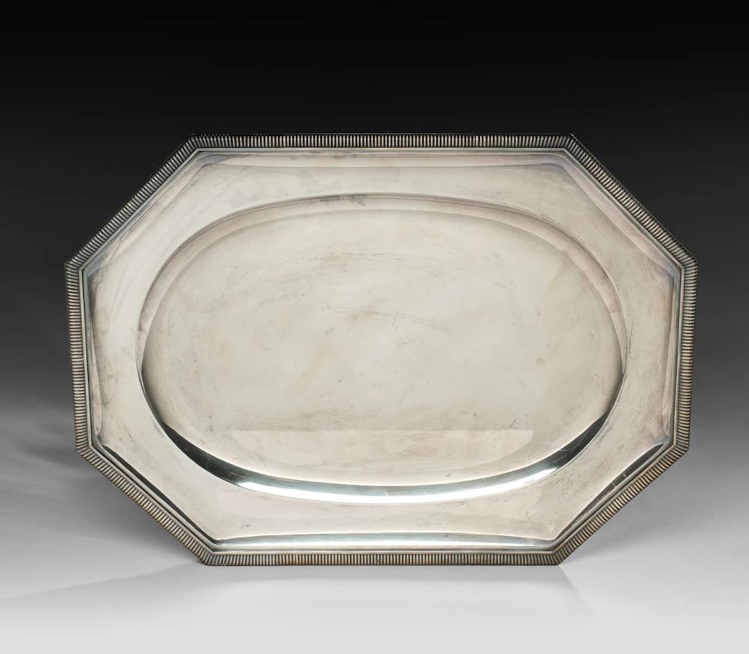 ODIOT, An octagonal silver tray with bevelled sides, the rim decorated