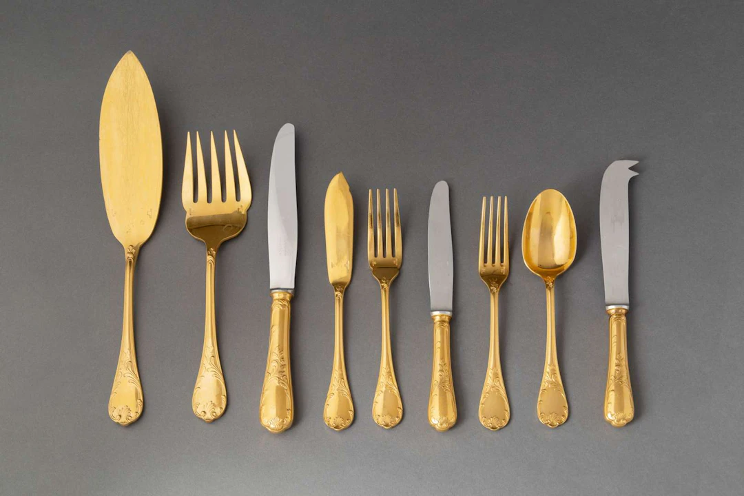 CHRISTOFLE, Set of gold-coloured metal kitchen utensils, ‘Marly’ model.