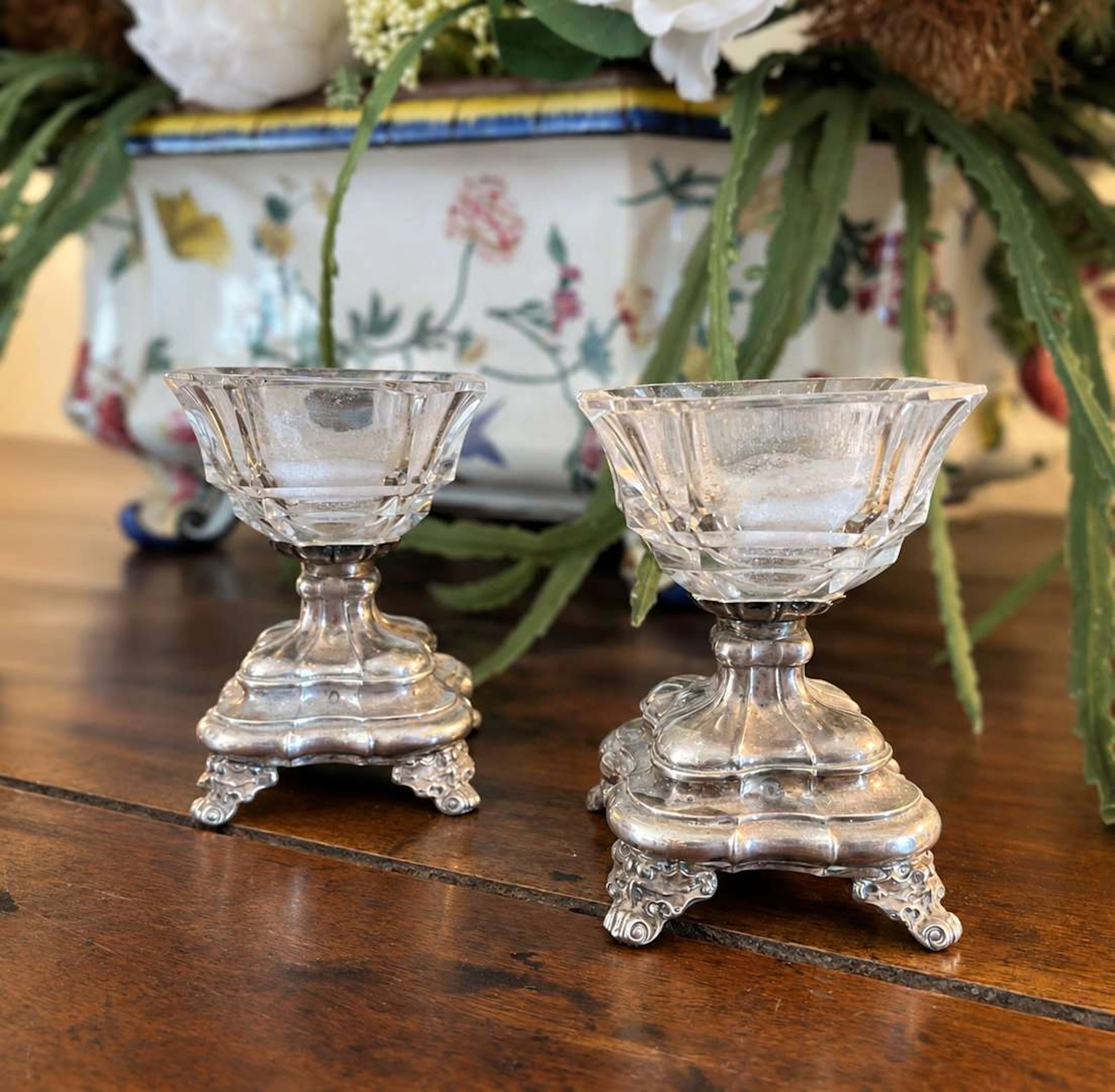 Pair of salt shakers, cut glass with a silver setting