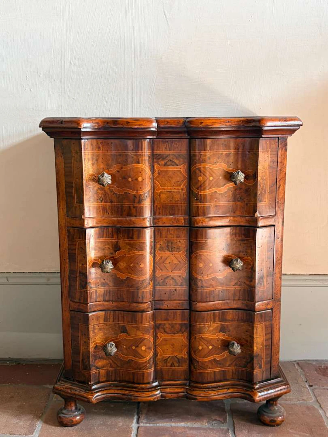 A small piece of furniture for in between, made of wood and marquetry