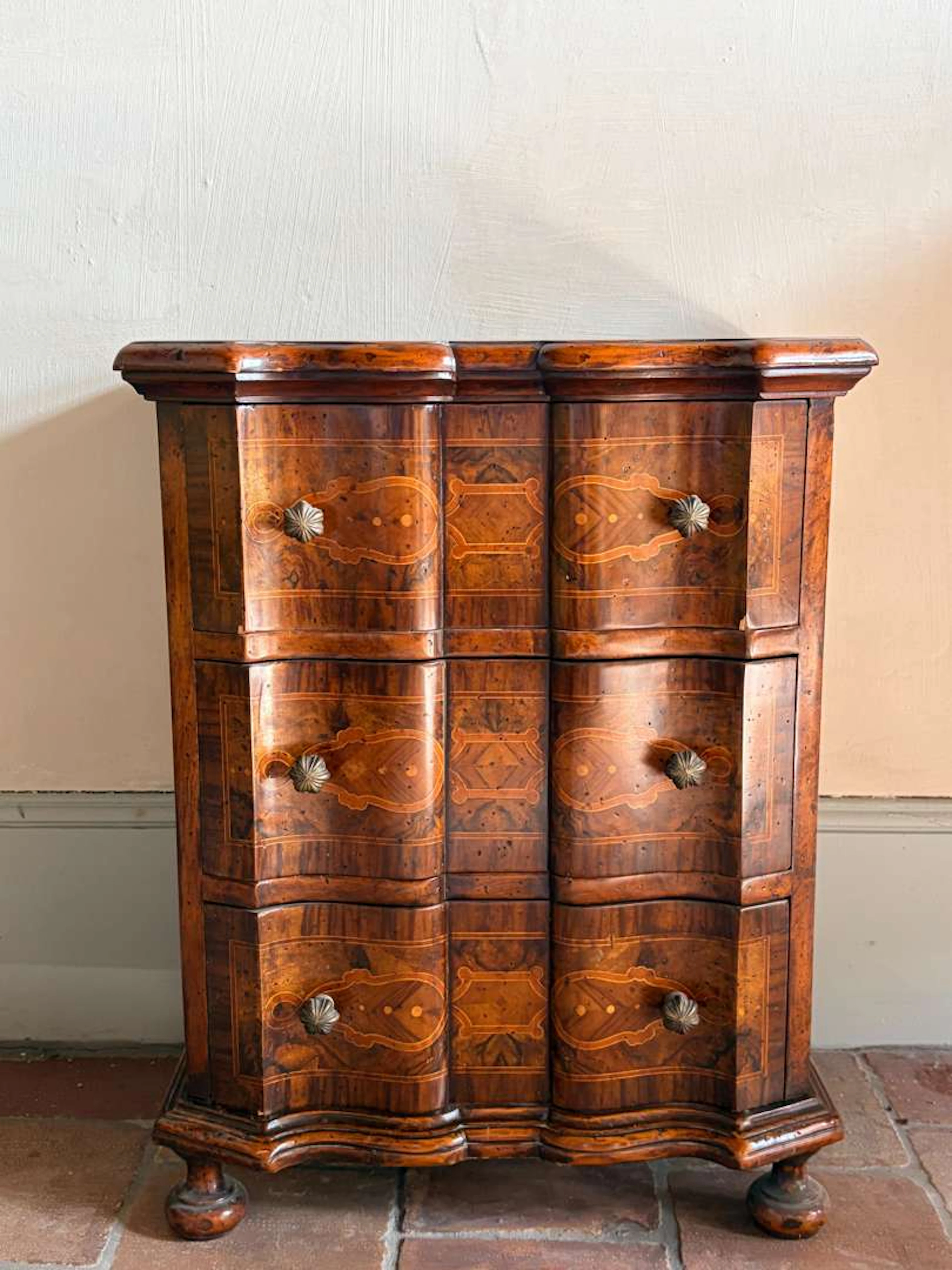 A small piece of furniture for in between, made of wood and marquetry