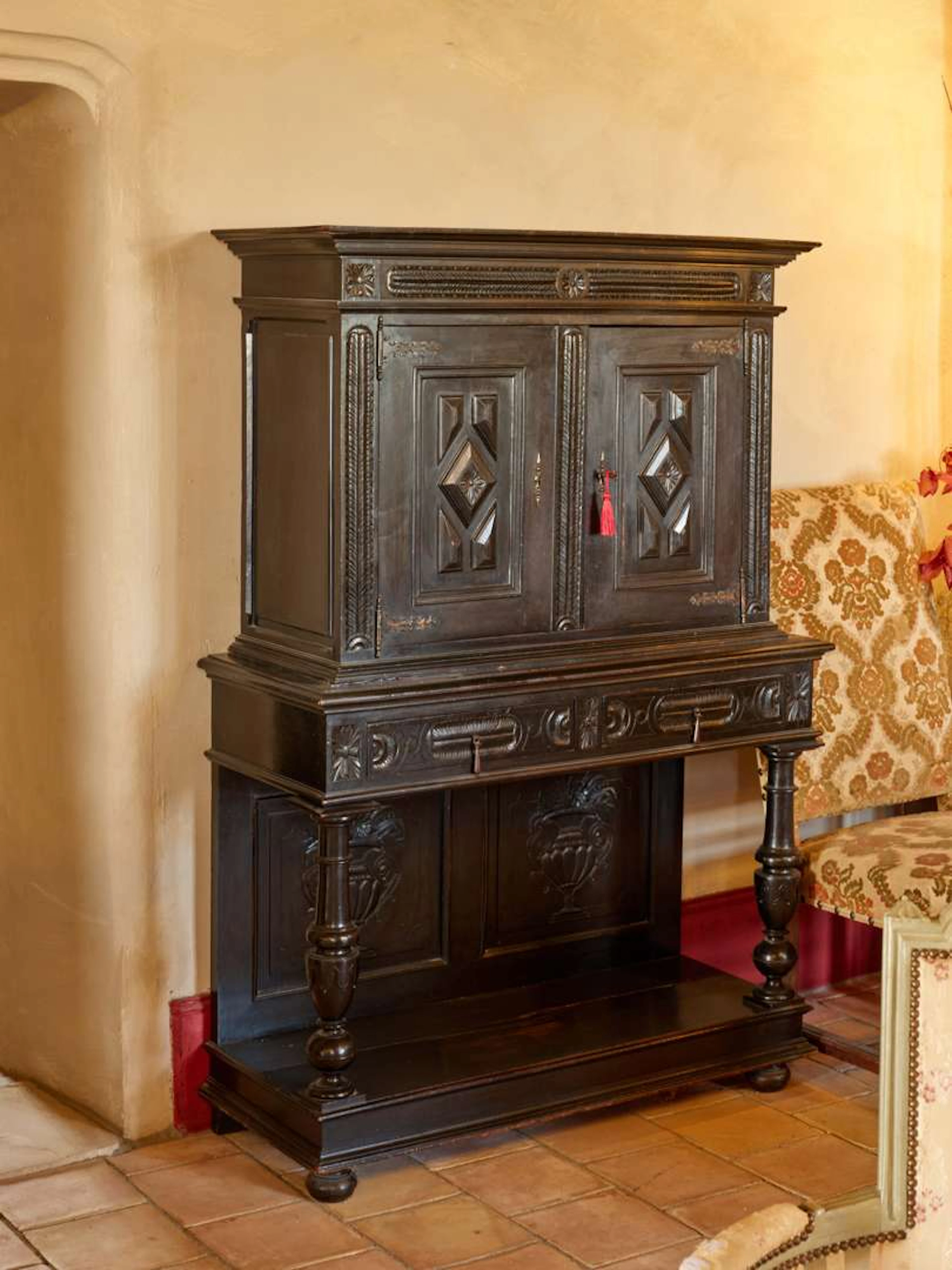 A cabinet in the Dutch style, made of carved and moulded blackened wood