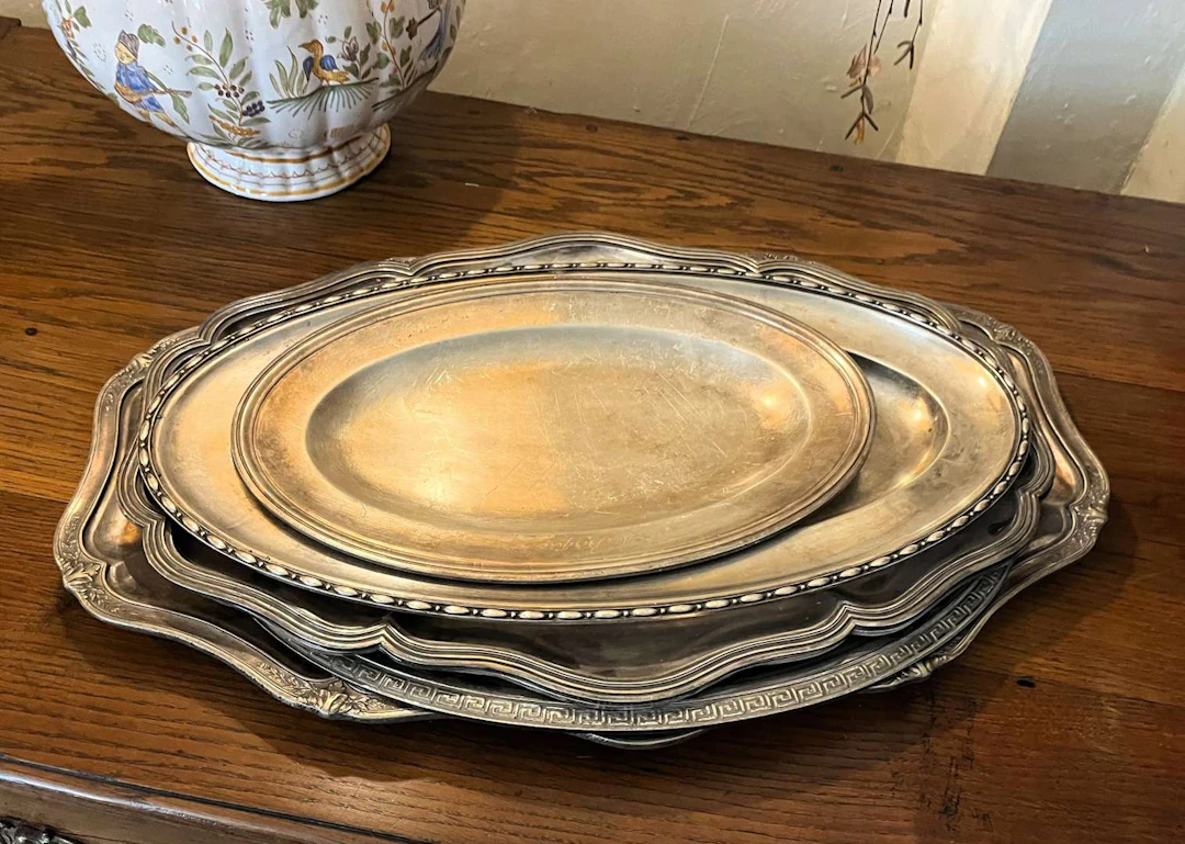 [TRAYS], Set of six oval trays in metal and silver-coloured metal