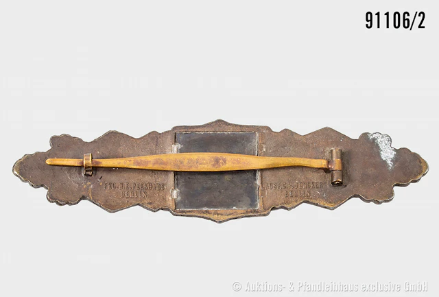 Nahkampfspange in Bronze, Zinkausführung, Herstelle "Juncker", dazugehöiges