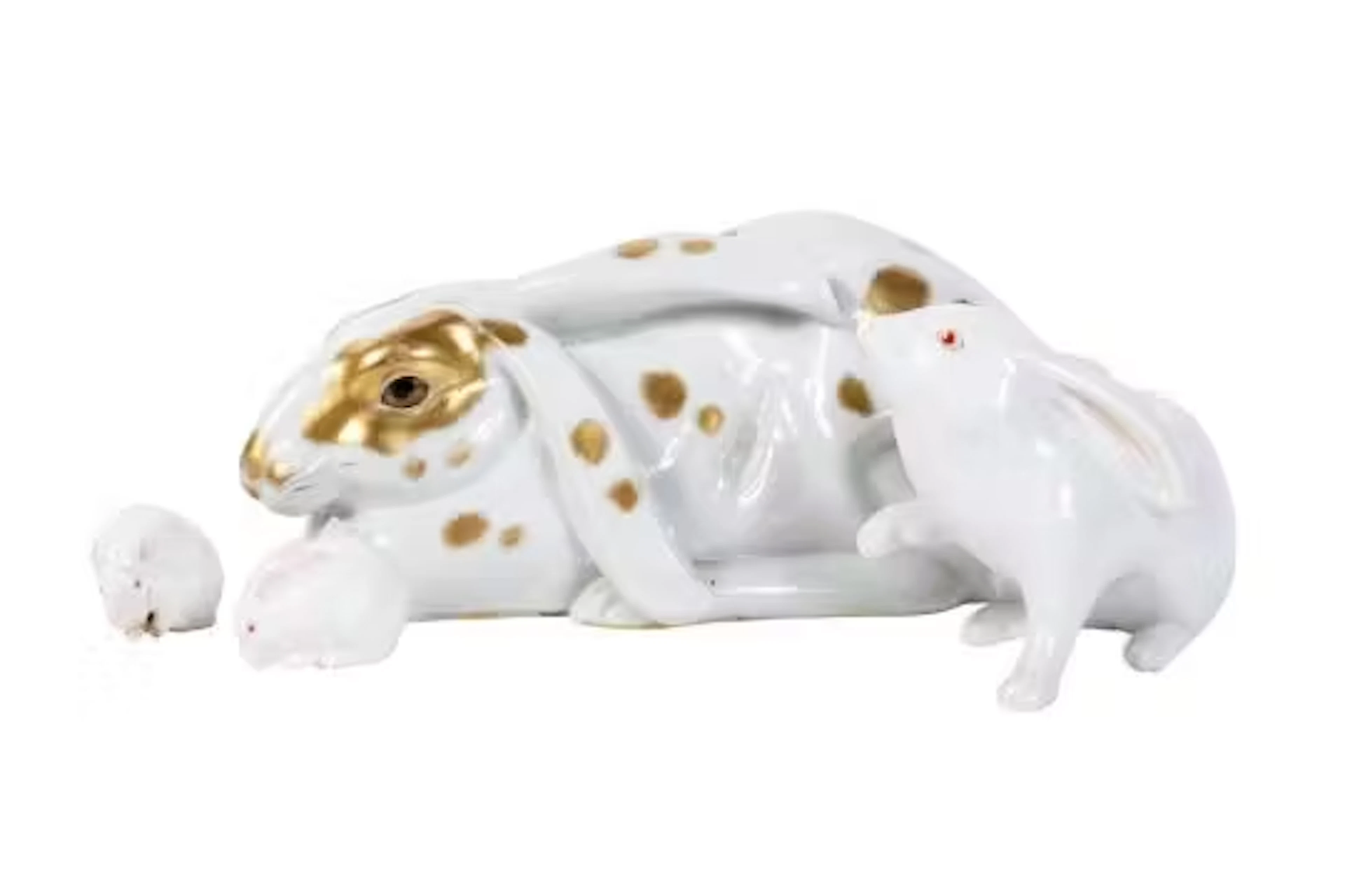Three porcelain rabbit figurines and a mouse.