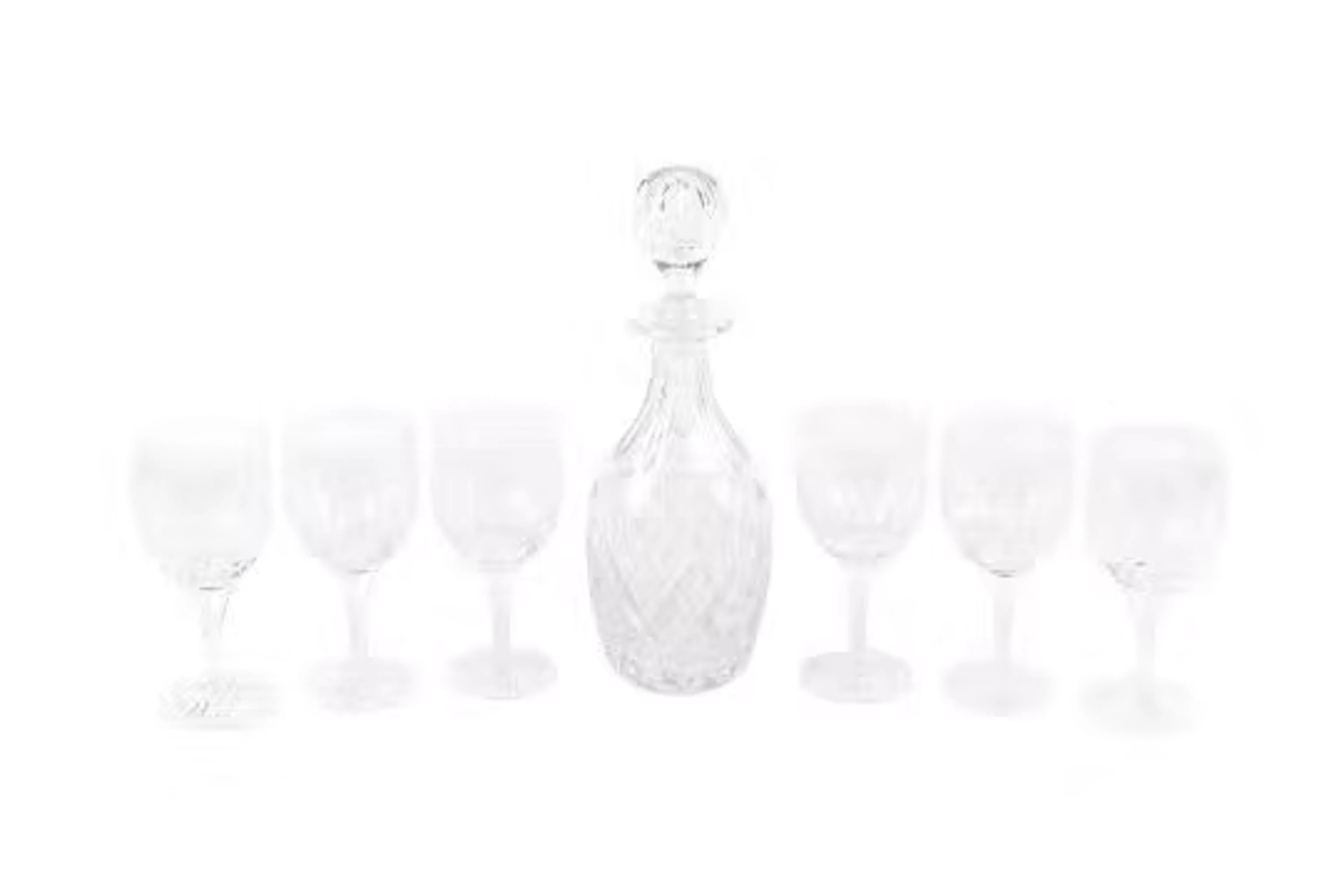 A glass decanter and a set of six matching wine glasses. Max.