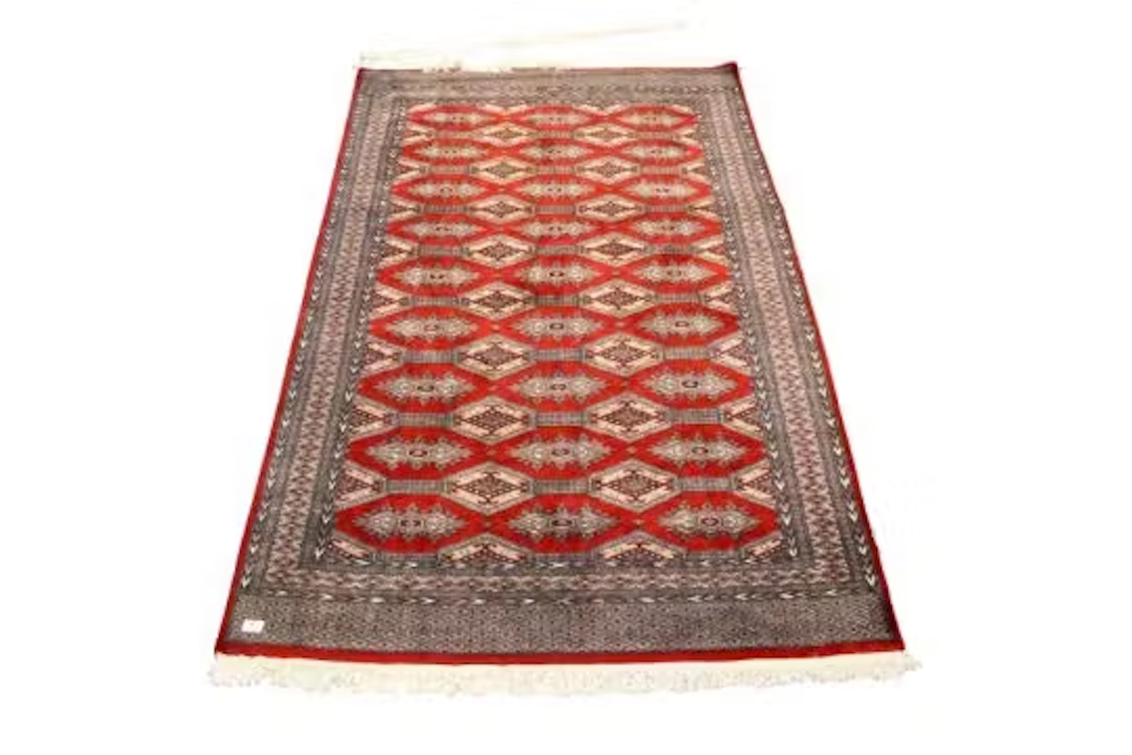 A contemporary Indian Bokhara style wool rug on a red ground.
