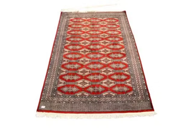 A contemporary Indian Bokhara style wool rug on a red ground.