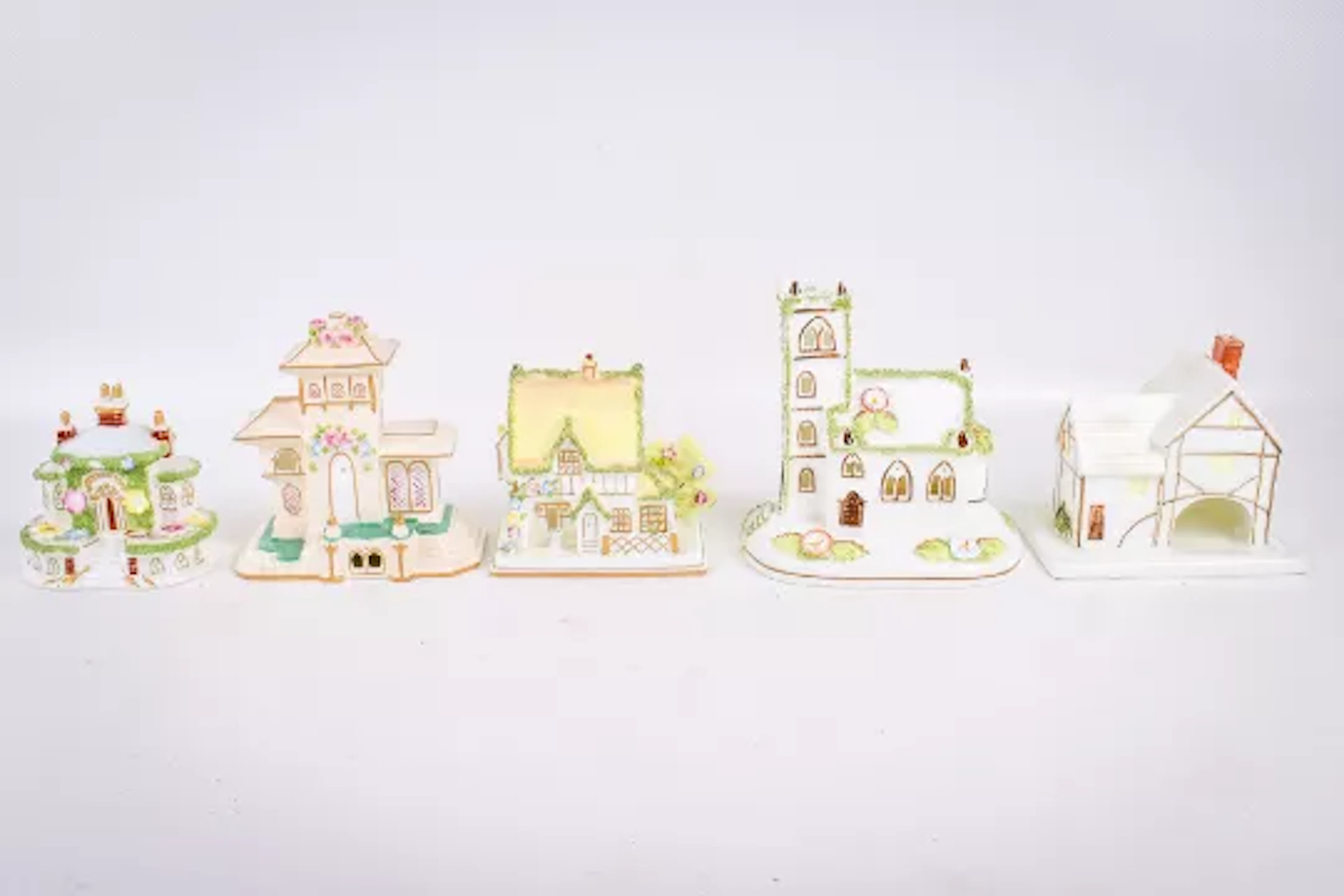 A group of five assorted Coalport china model buildings.