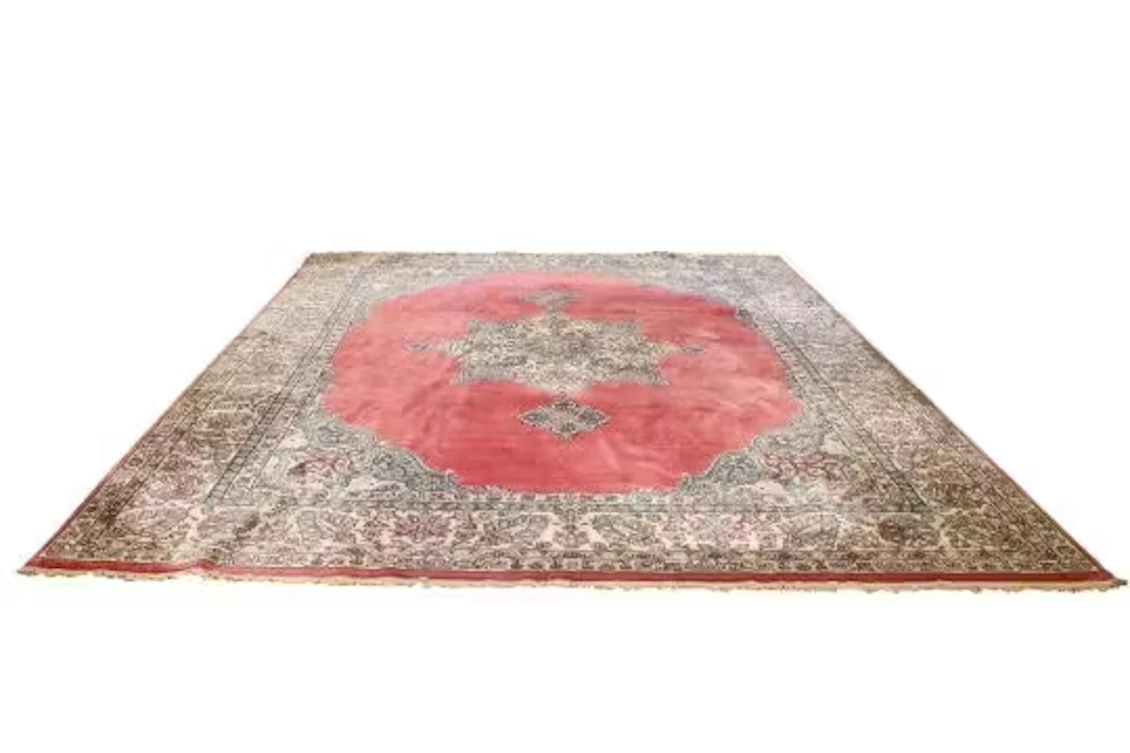 A large Persian style pink ground wool rug.