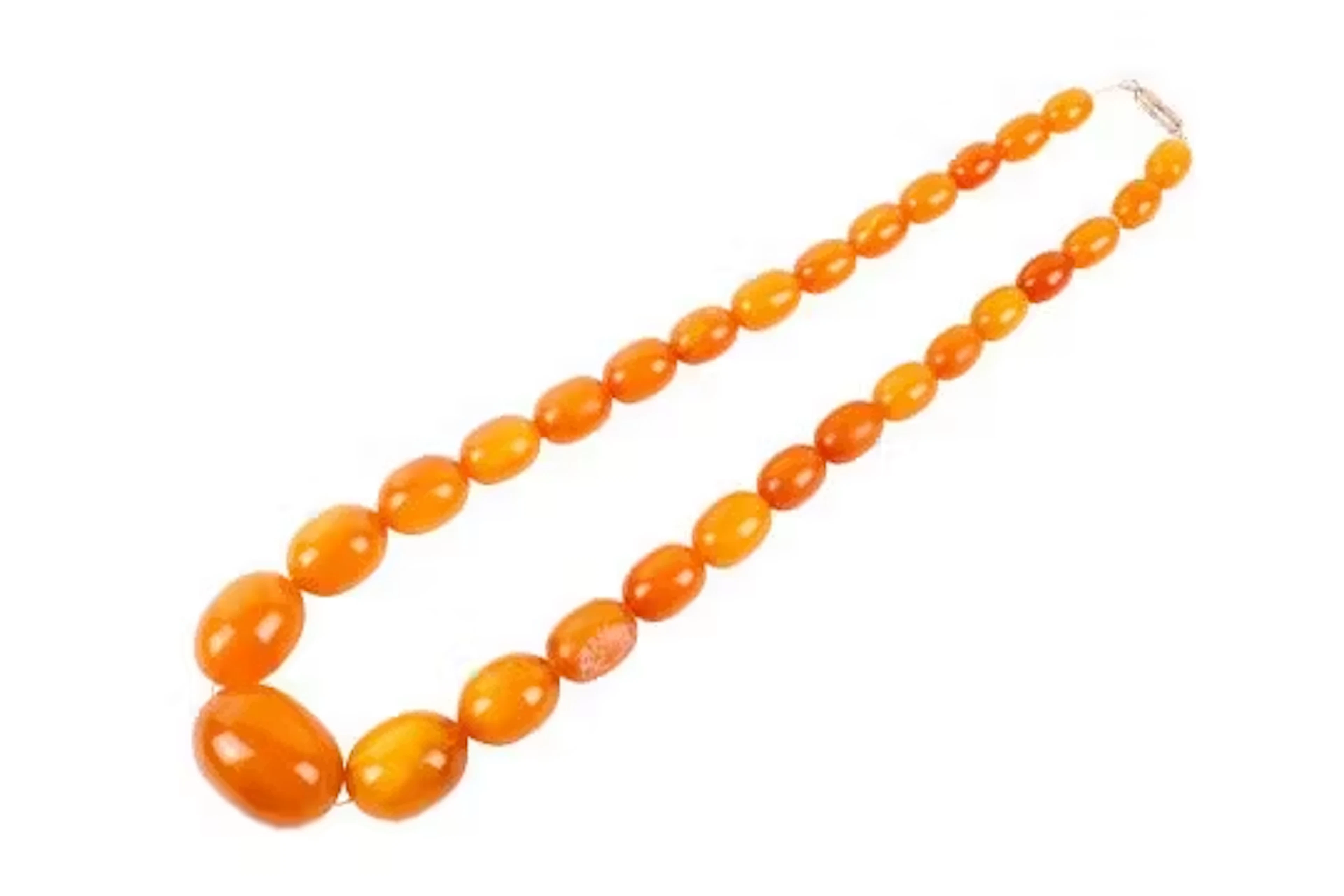 A butterscotch amber graduated bead necklace. Bead length circa 1cm