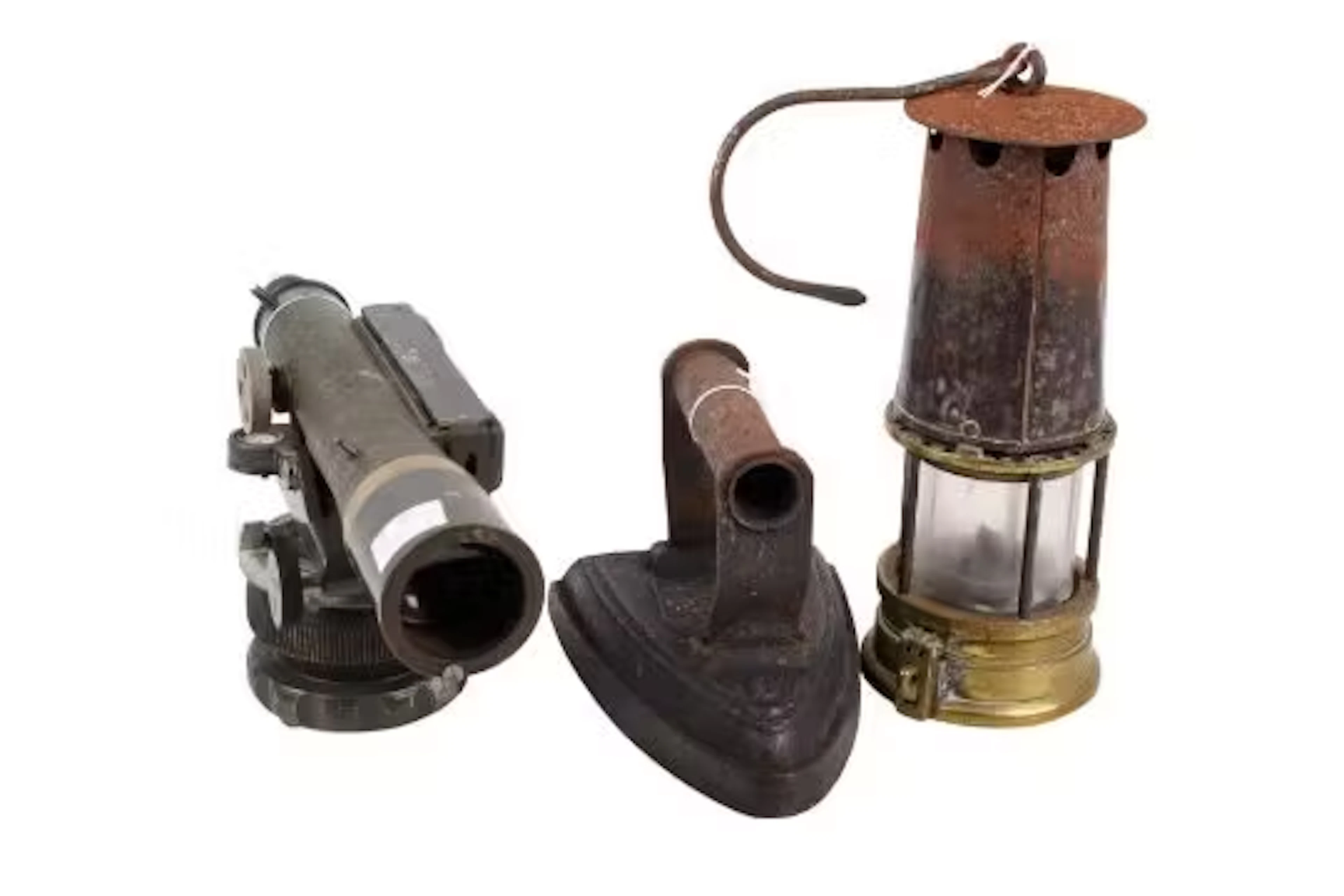 A vintage cast iron, Watts theodolite and a miner's lamp. The lamp
