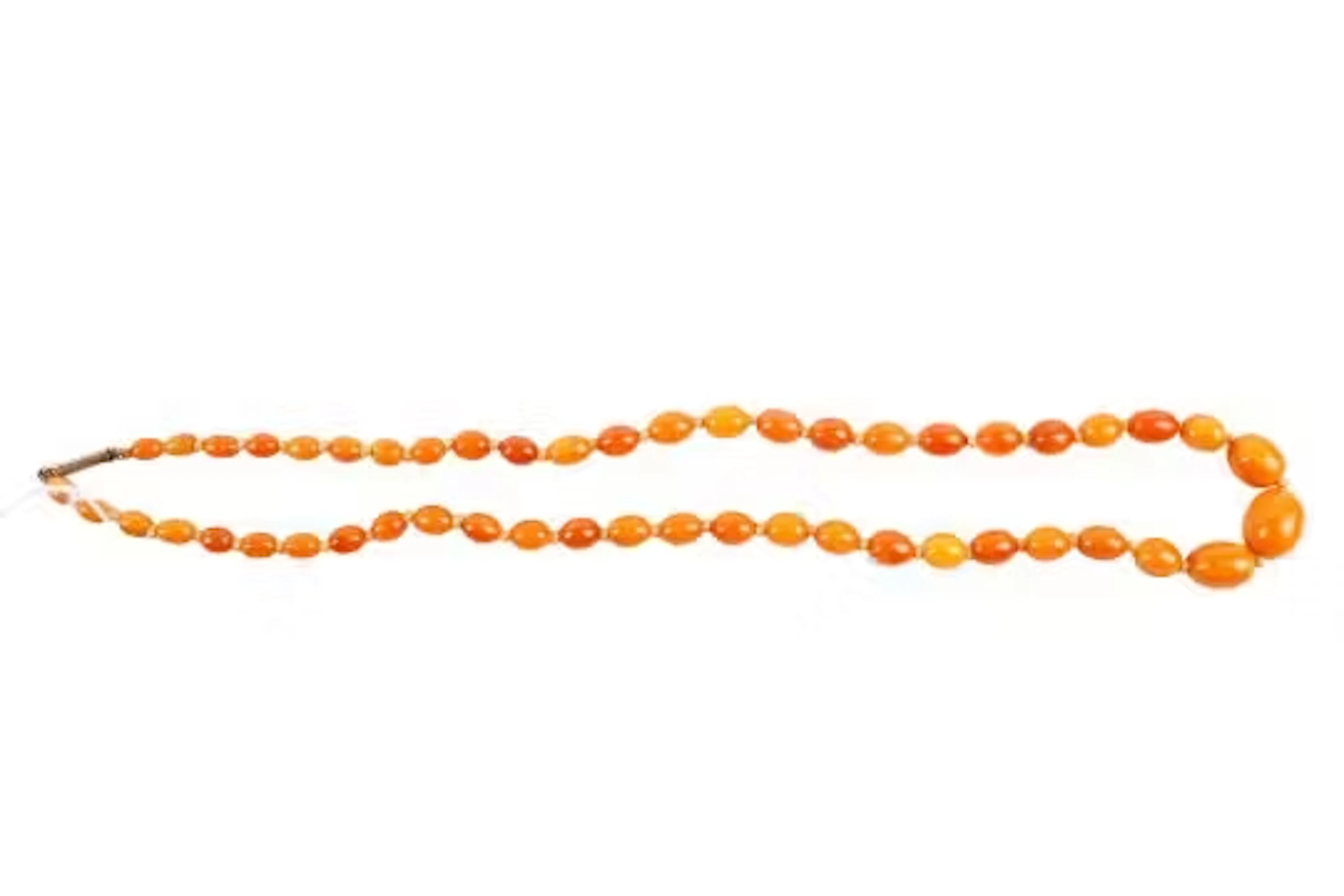 A butterscotch amber bead necklace. The oval beads from circa 58mmx