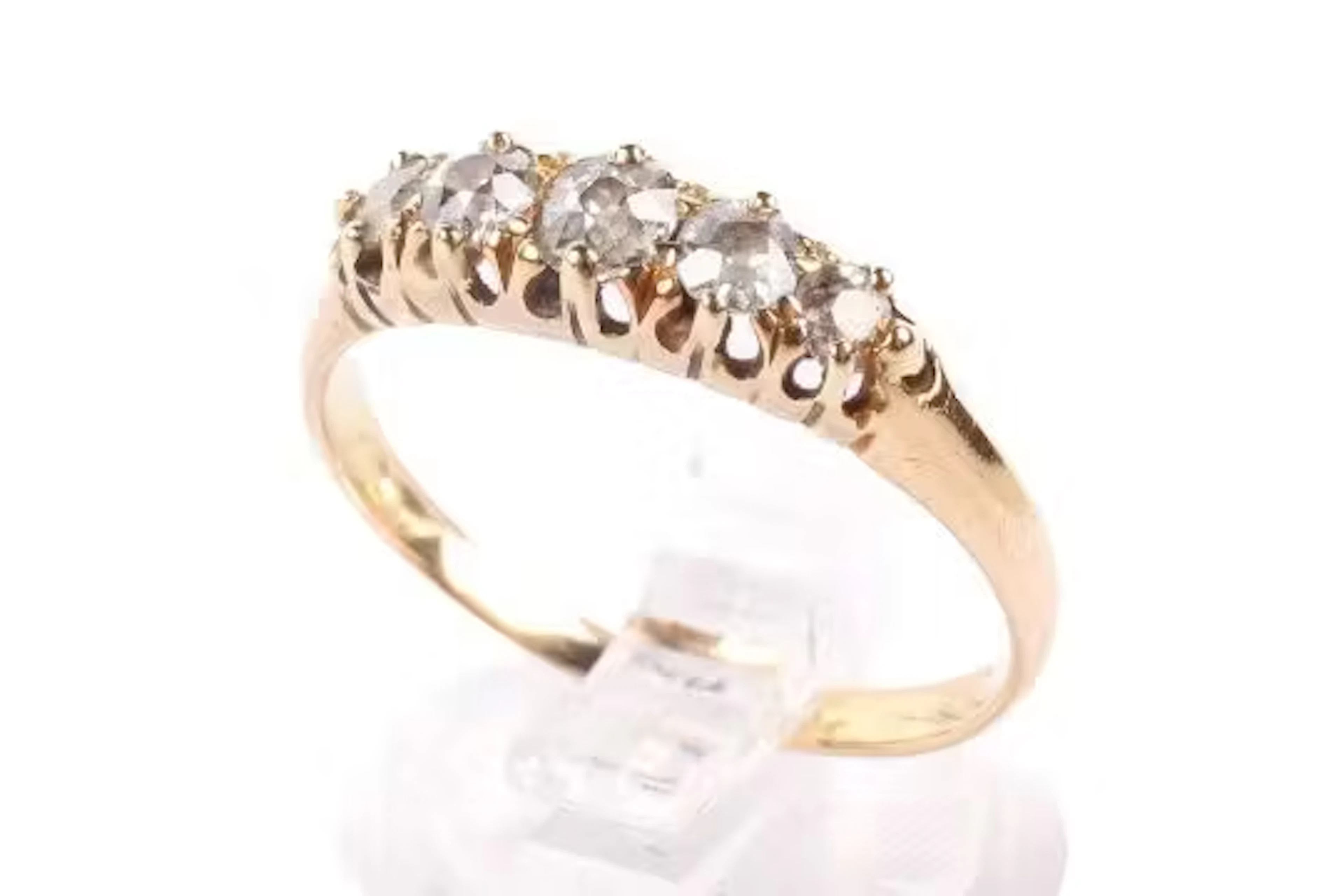A yellow metal diamond ring.