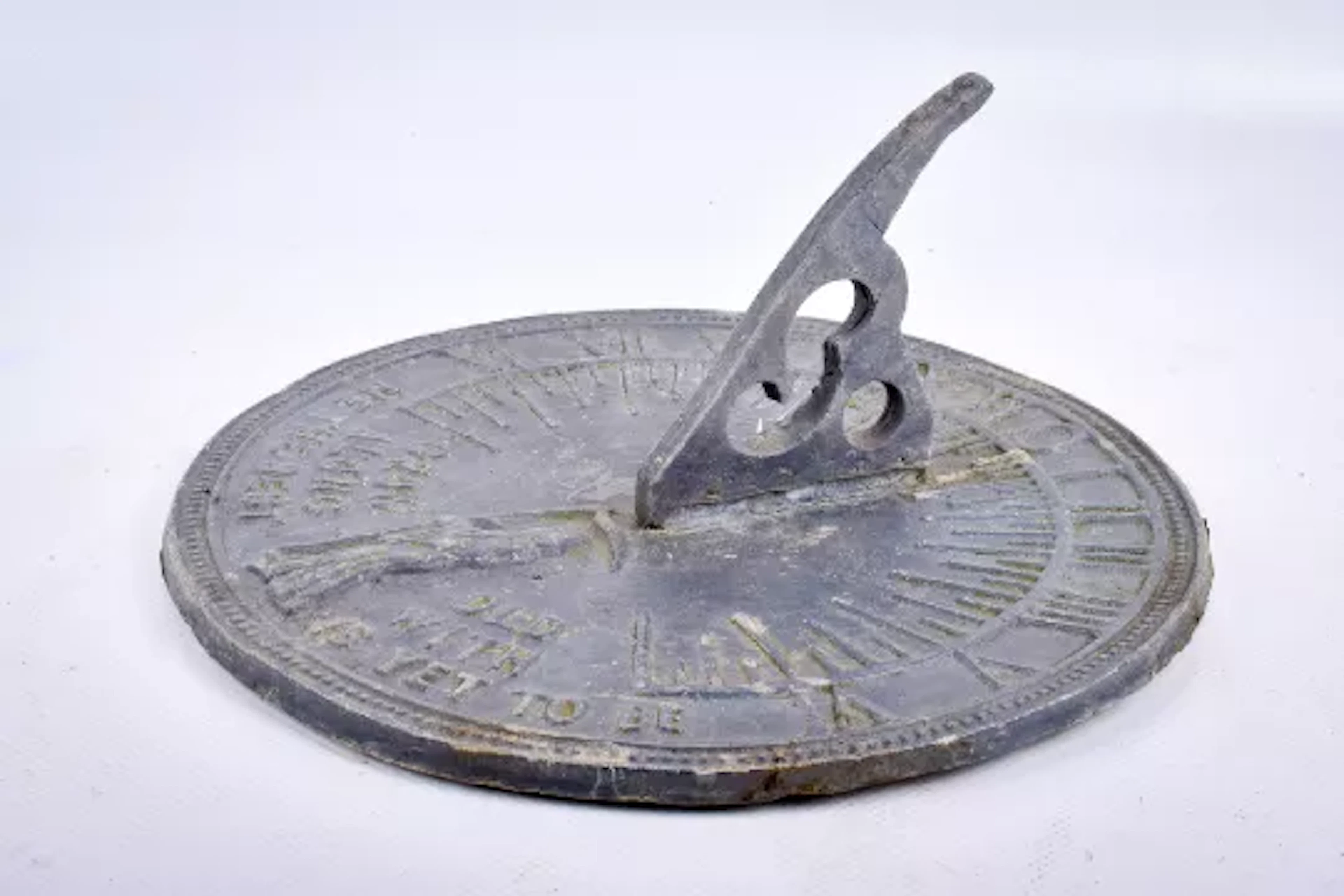 A lead sundial, 'Grow Old Along With Me The Best Is Yet To Be'.