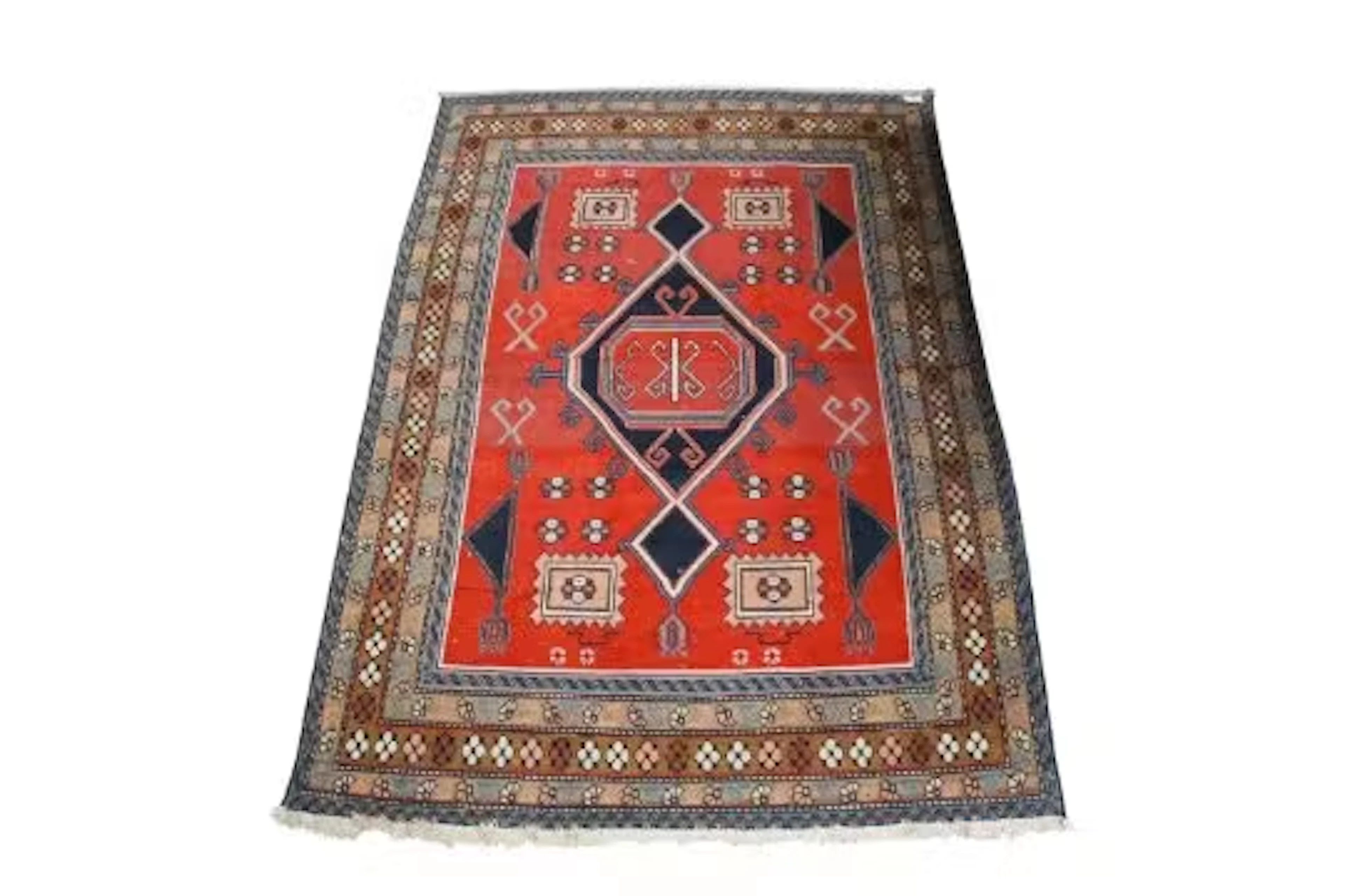 A Persian style wool rug on a red ground.