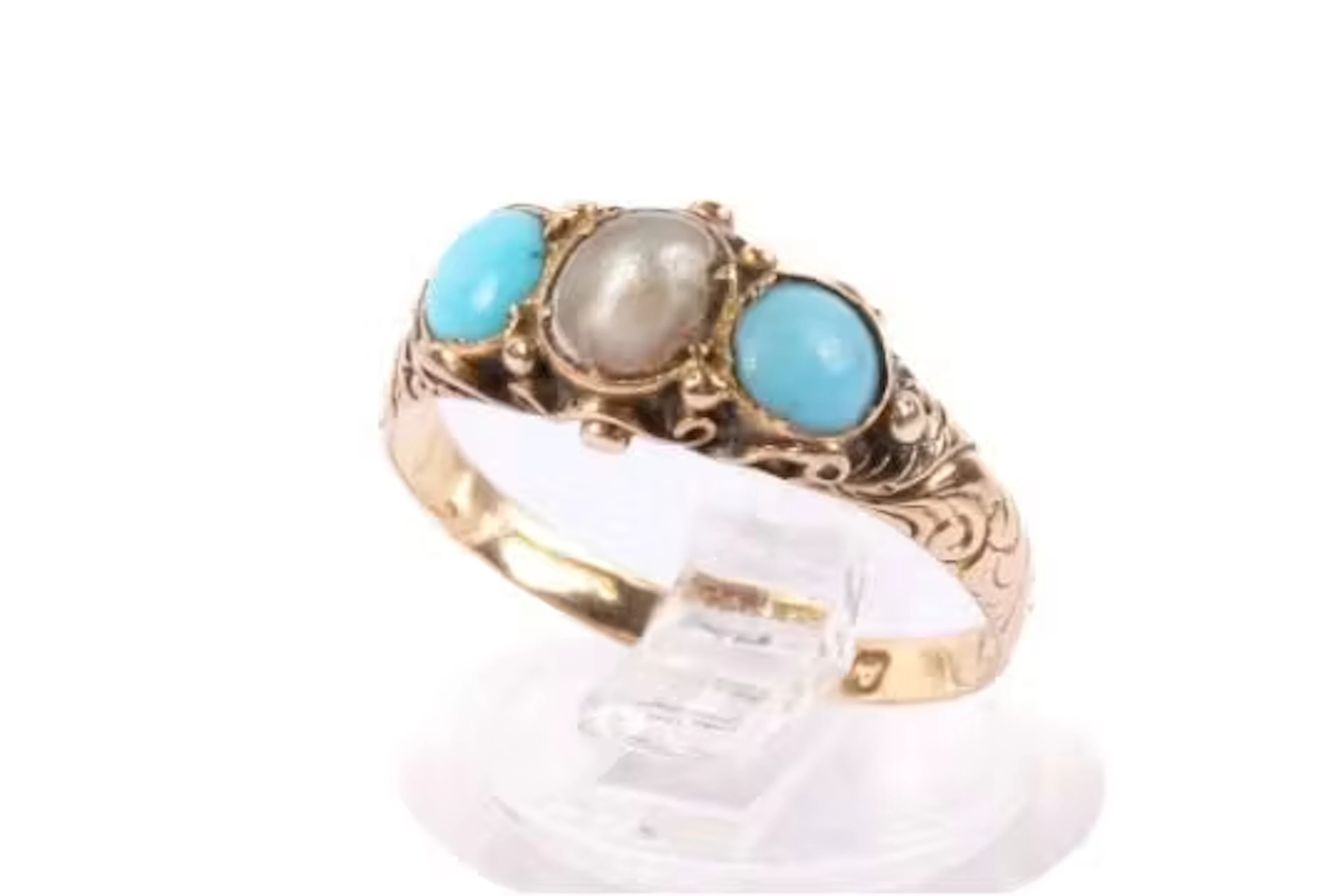 A 15ct gold dress ring. Set with a half pearl and turquoise cabochons