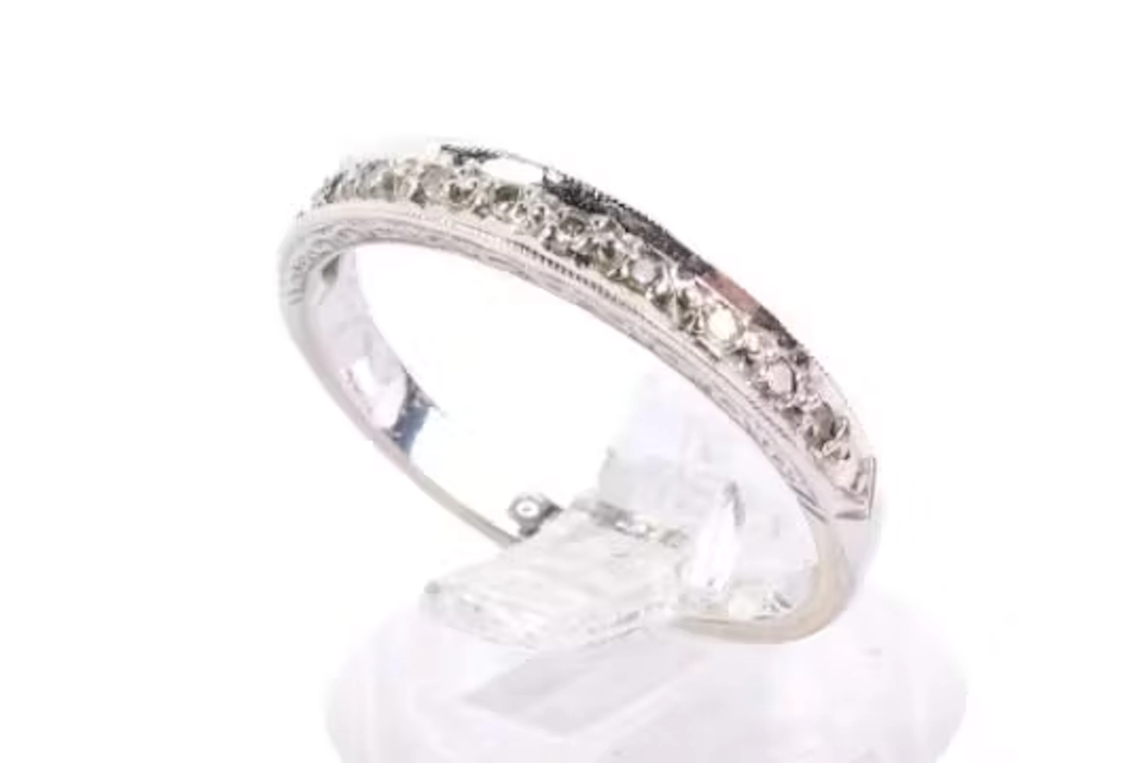 An 18ct gold half eternity diamond ring. Set with single cut diamonds