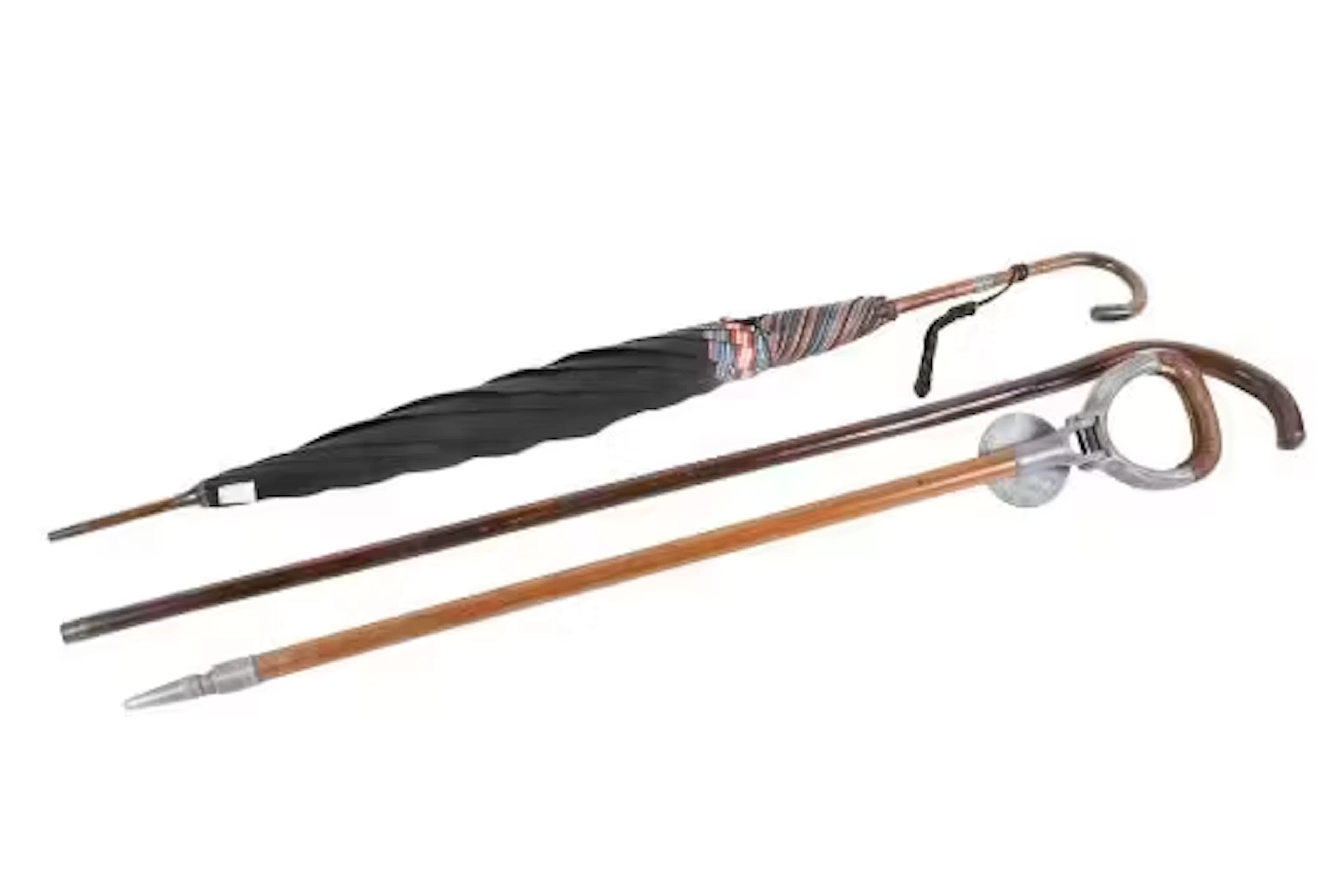 A women's silver collared vintage umbrella, a shooting stick and walking stick.