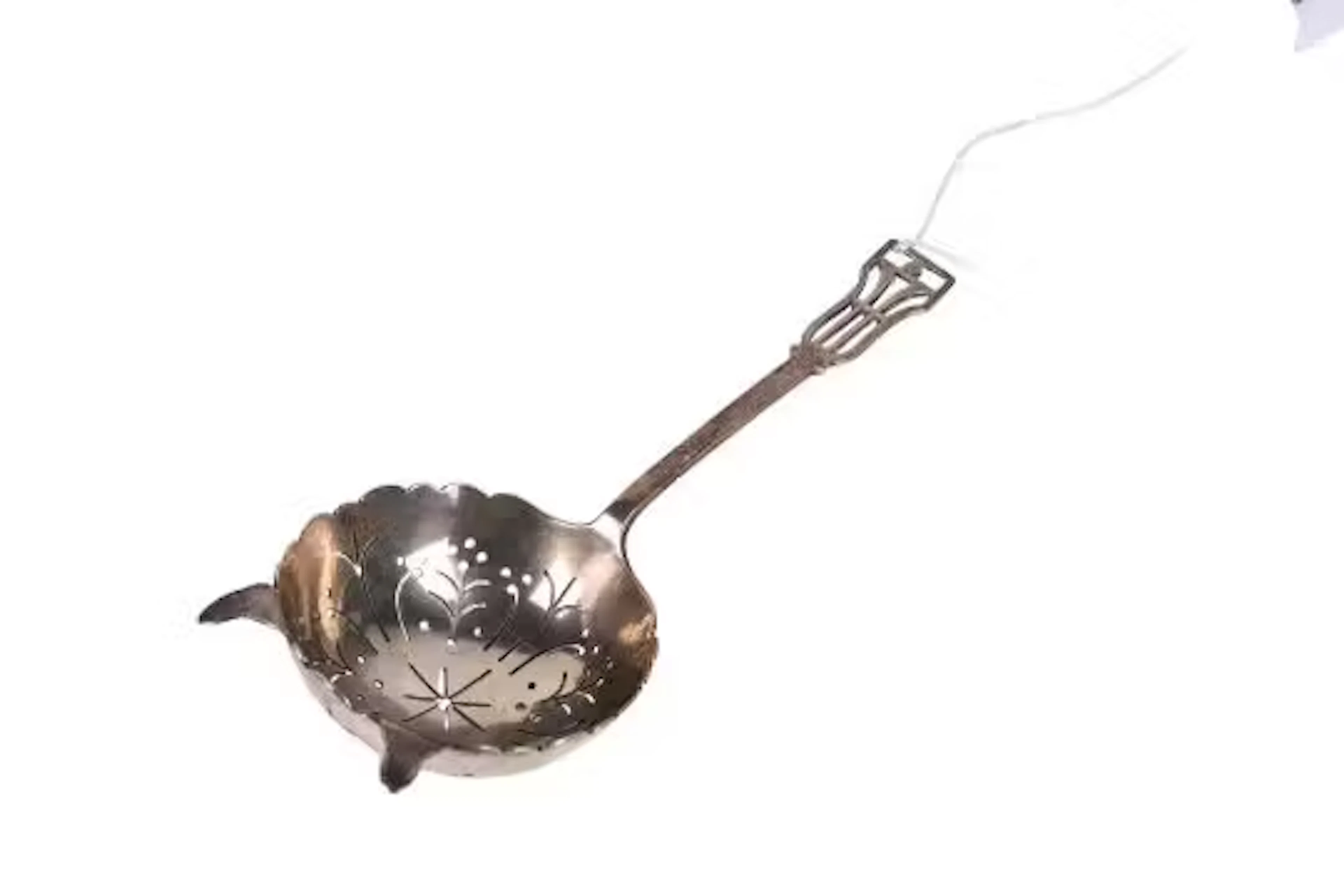 A mid-century silver tea leaf strainer.