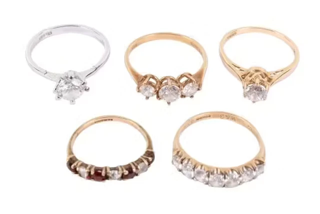 Five stone set rings. Comprising three hallmarked 9ct gold rings