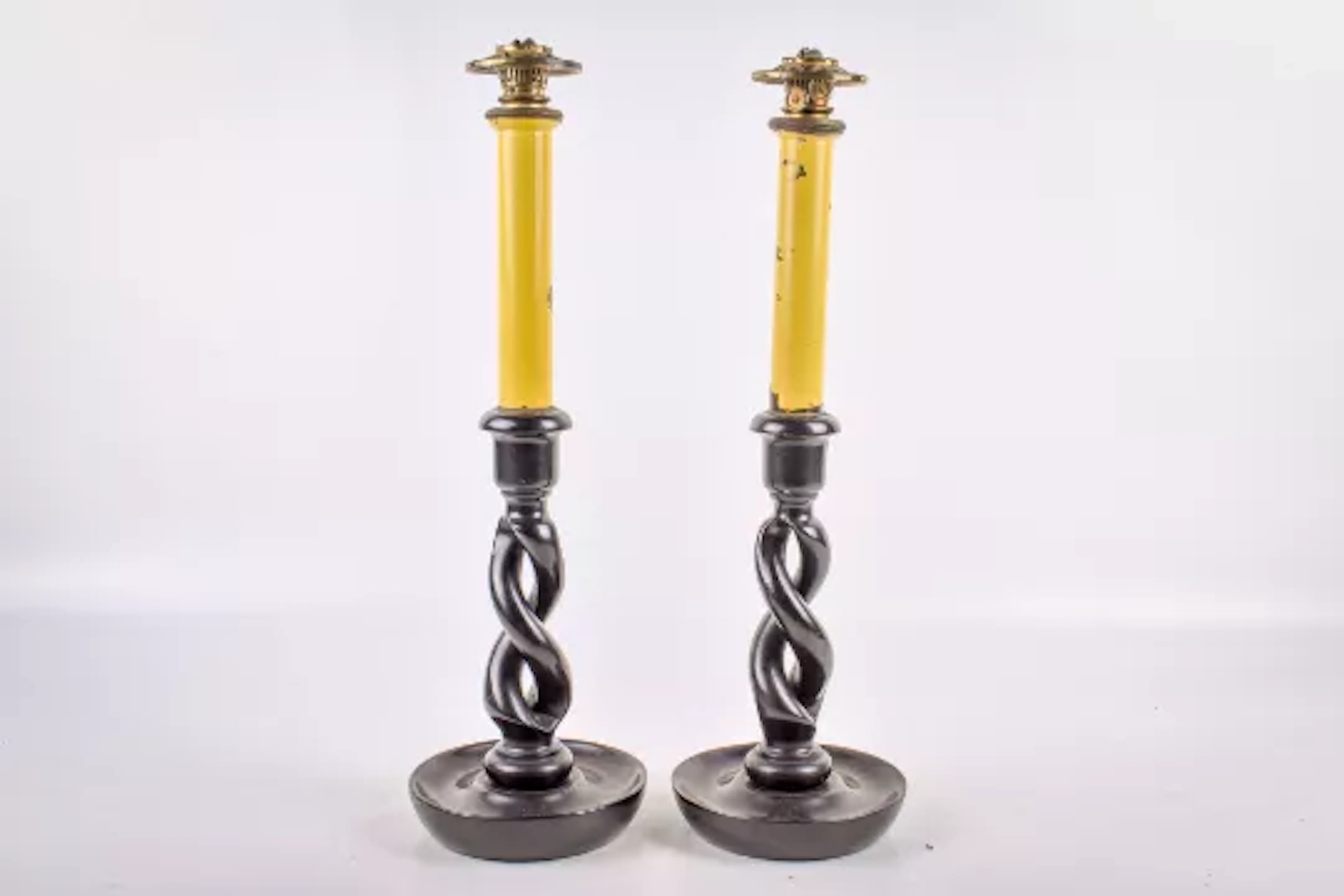 A pair of oil lamps modelled as candlesticks. With ebonized twist bases.