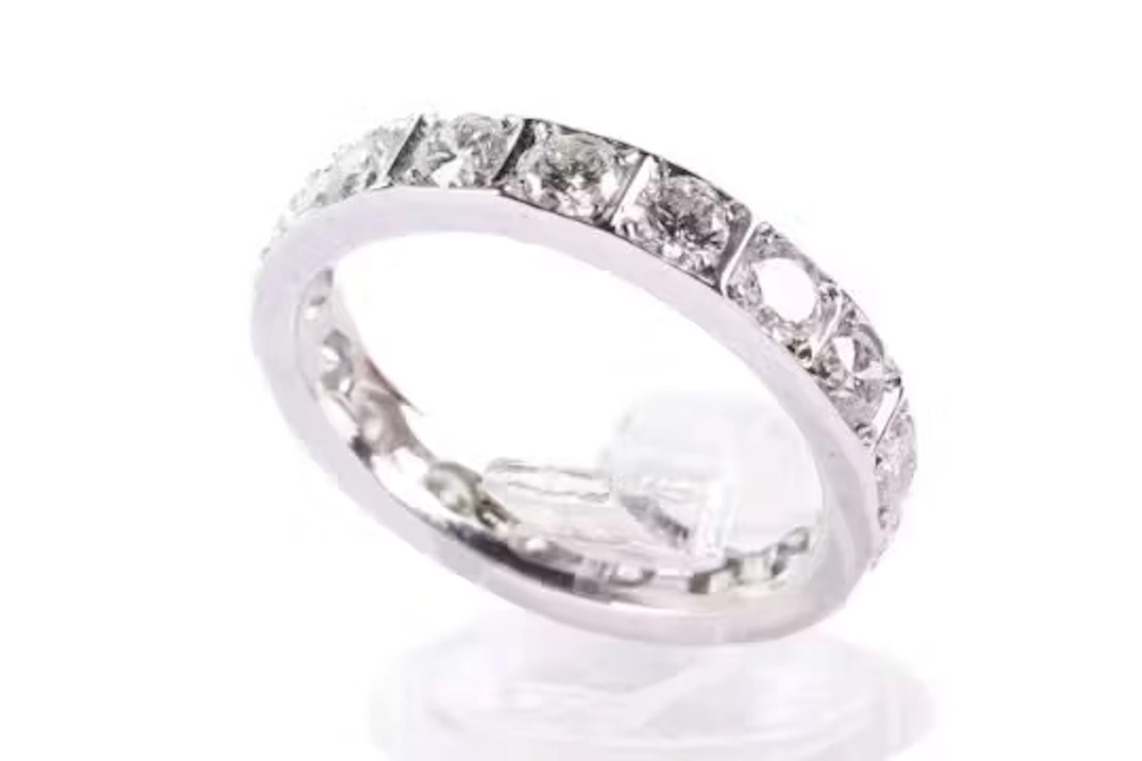 A platinum and diamond eternity ring. With 17 round cut diamonds, each circa 3.