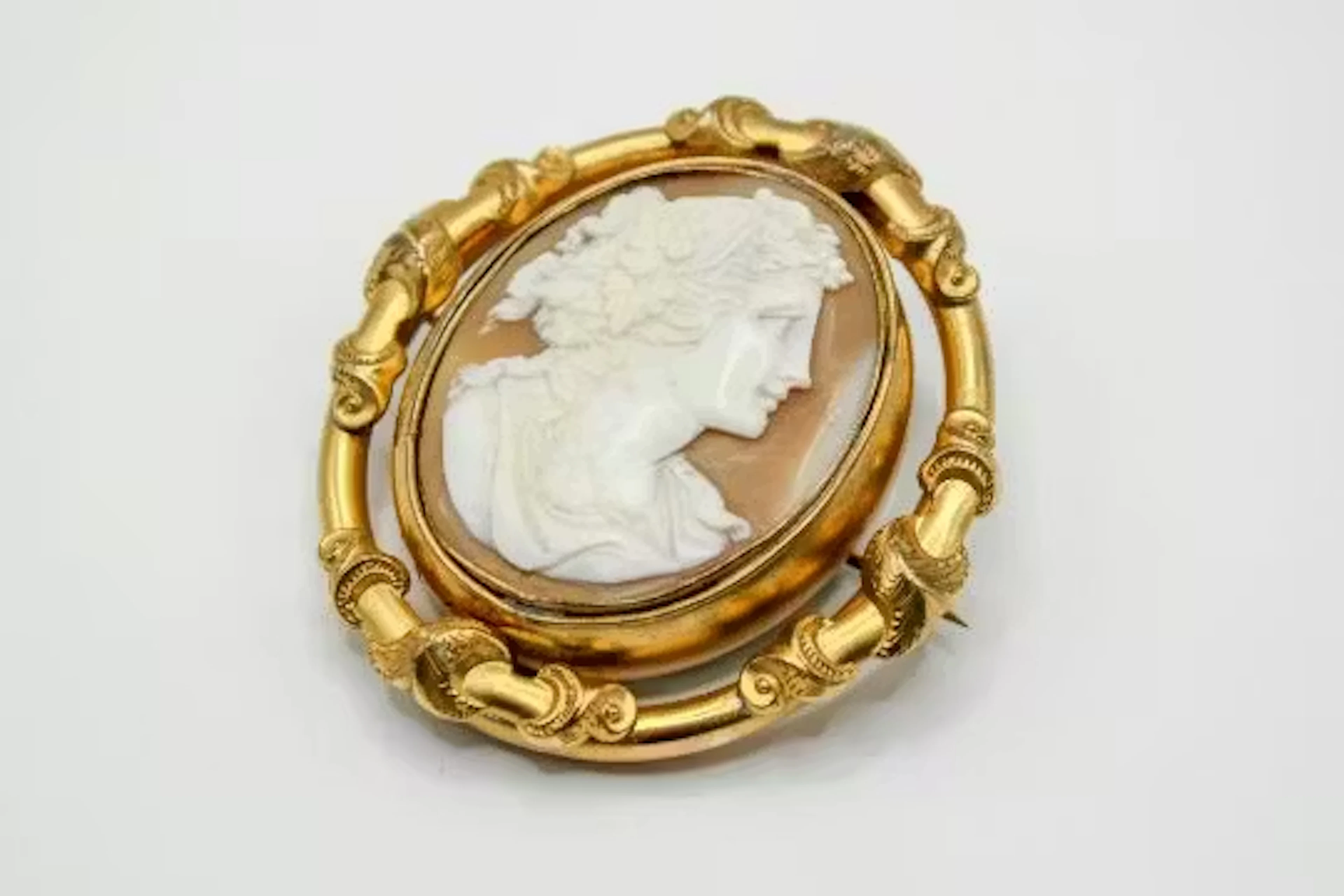 A Victorian gold plated swivel cameo brooch.