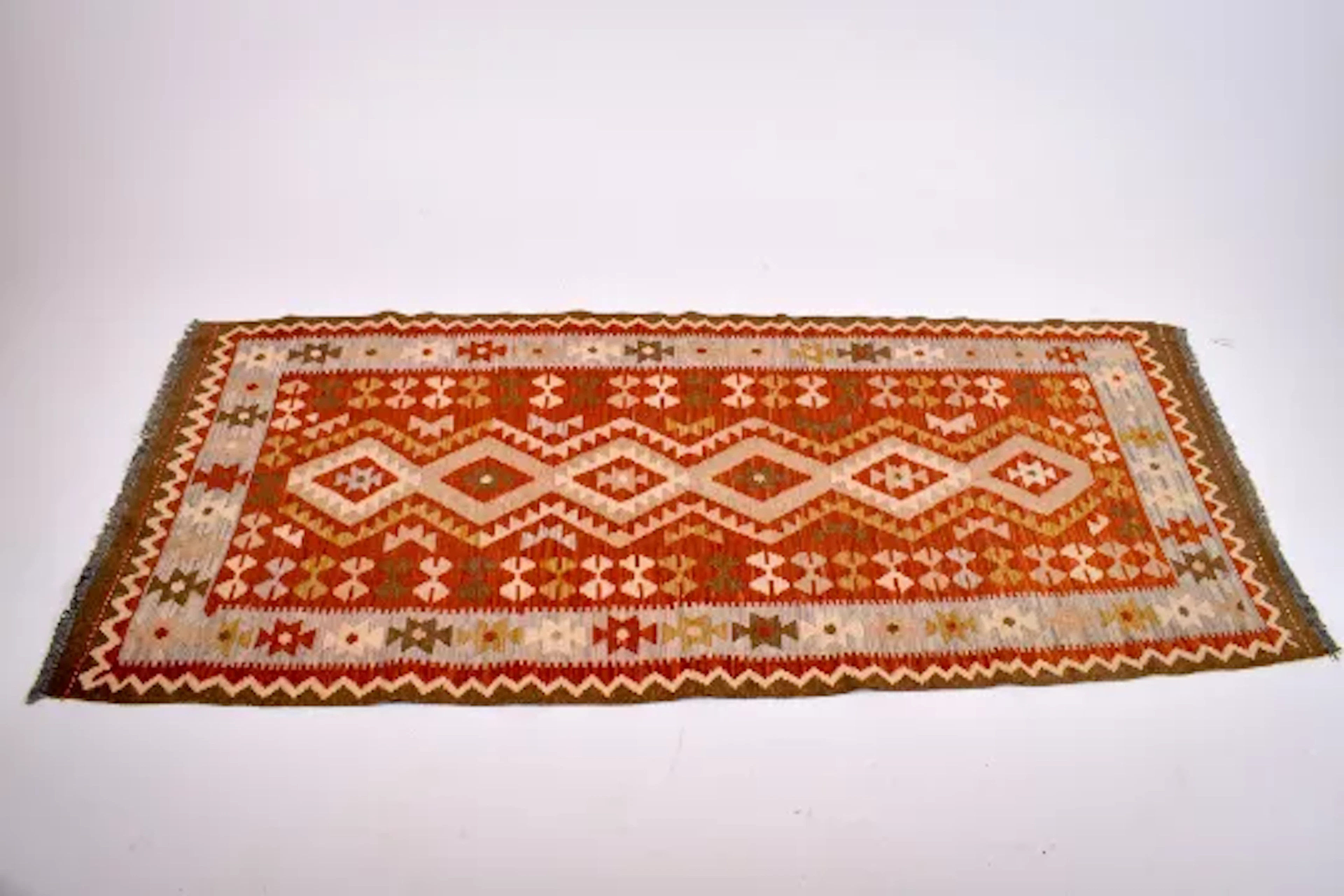 A Kilim rug runner. Having a geometric design in beige and pale blue