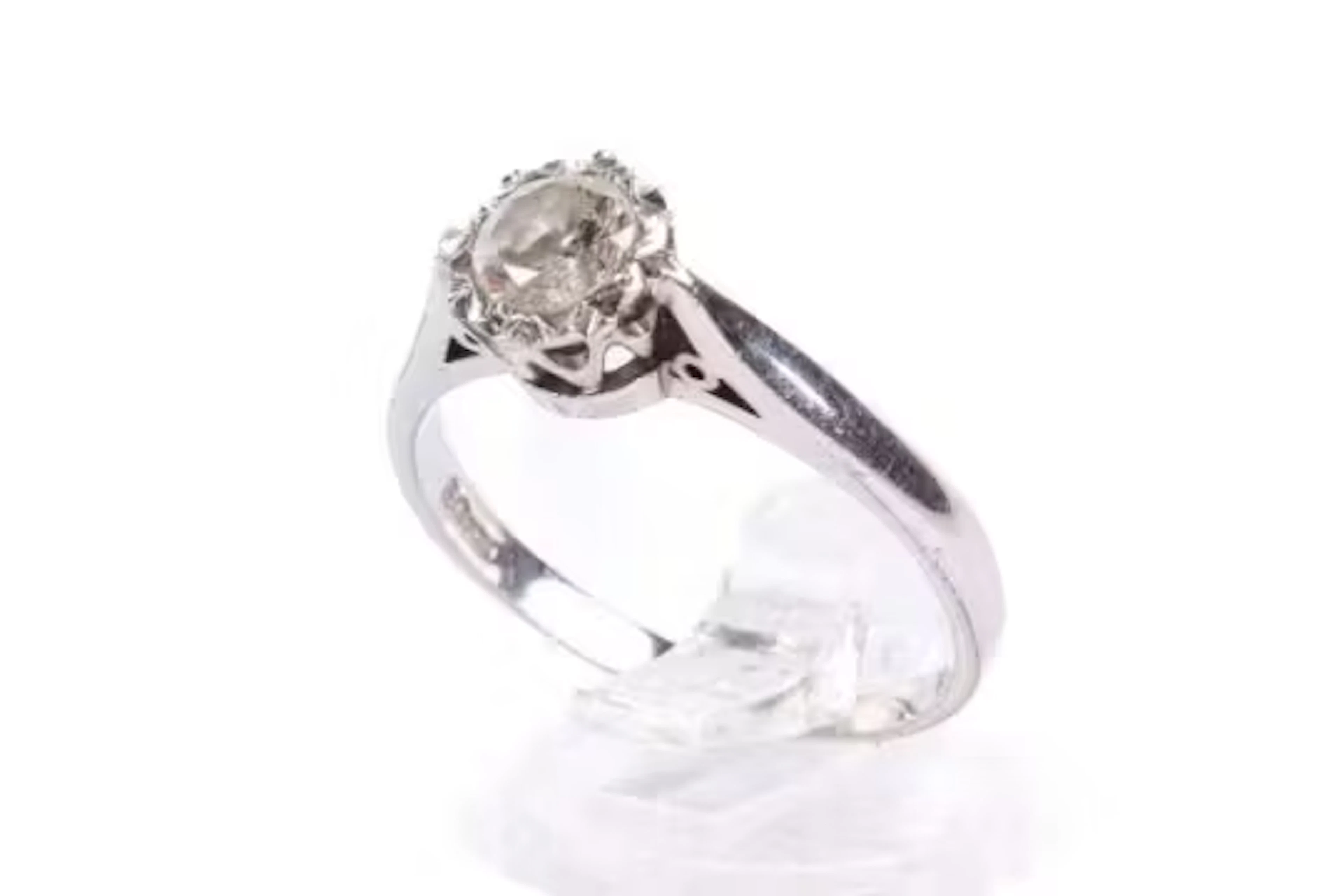 A 9ct white gold diamond solitaire ring. Set with one round brilliant
