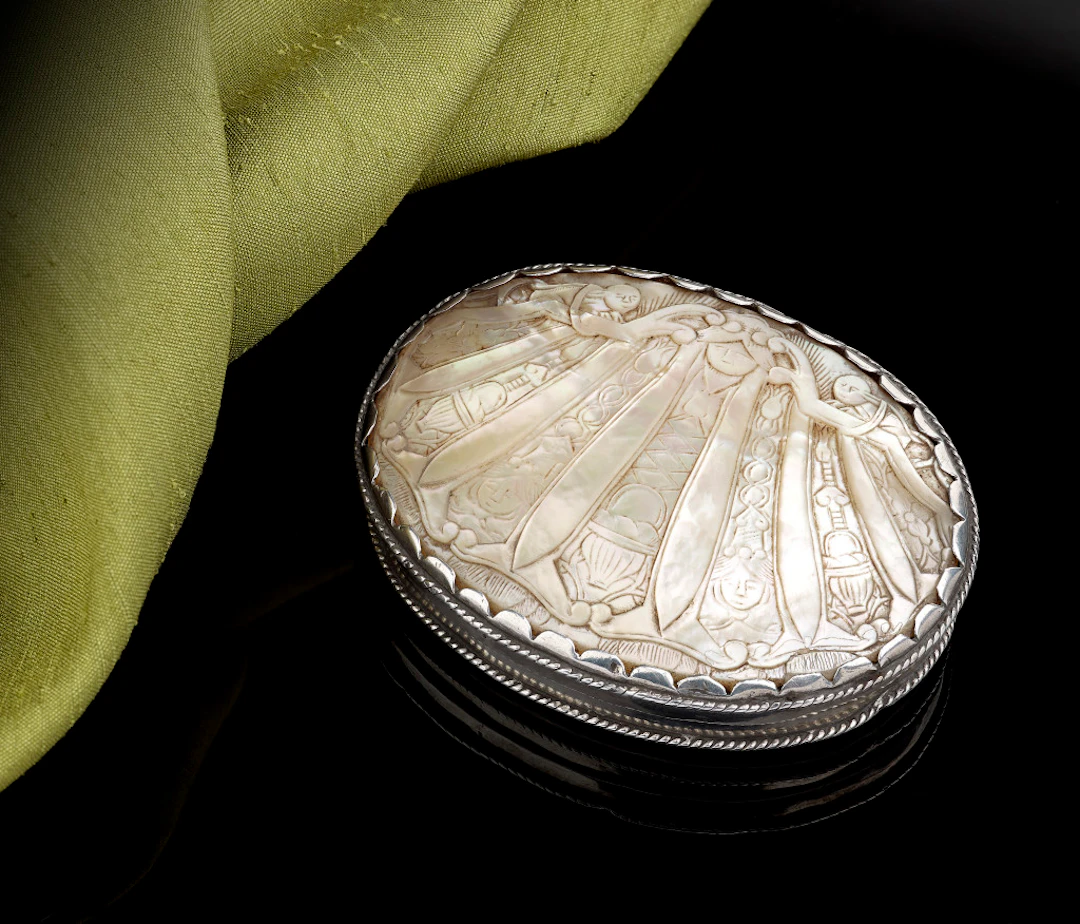 A little carved mother of pearl box with silver mounts, 17th Century