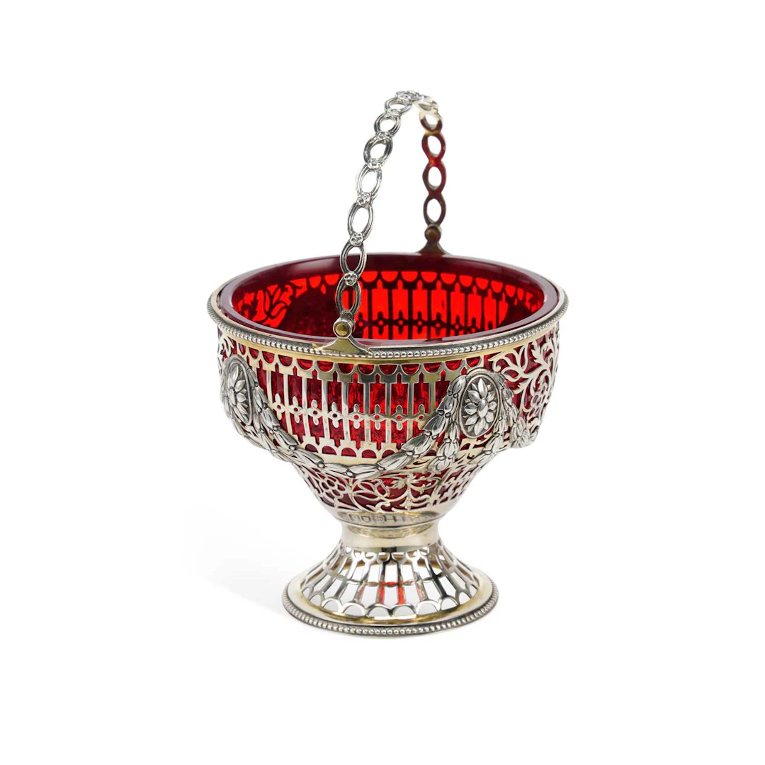 AN EDWARDIAN PIERCED SILVER SUGAR BASKET