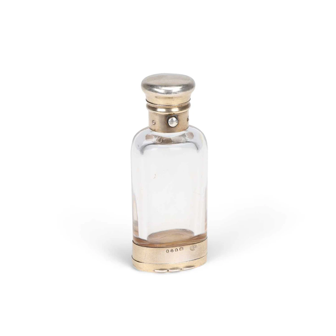 A VICTORIAN SILVER-GILT MOUNTED GLASS COMBINATION SCENT BOTTLE AND VINAIGRETTE