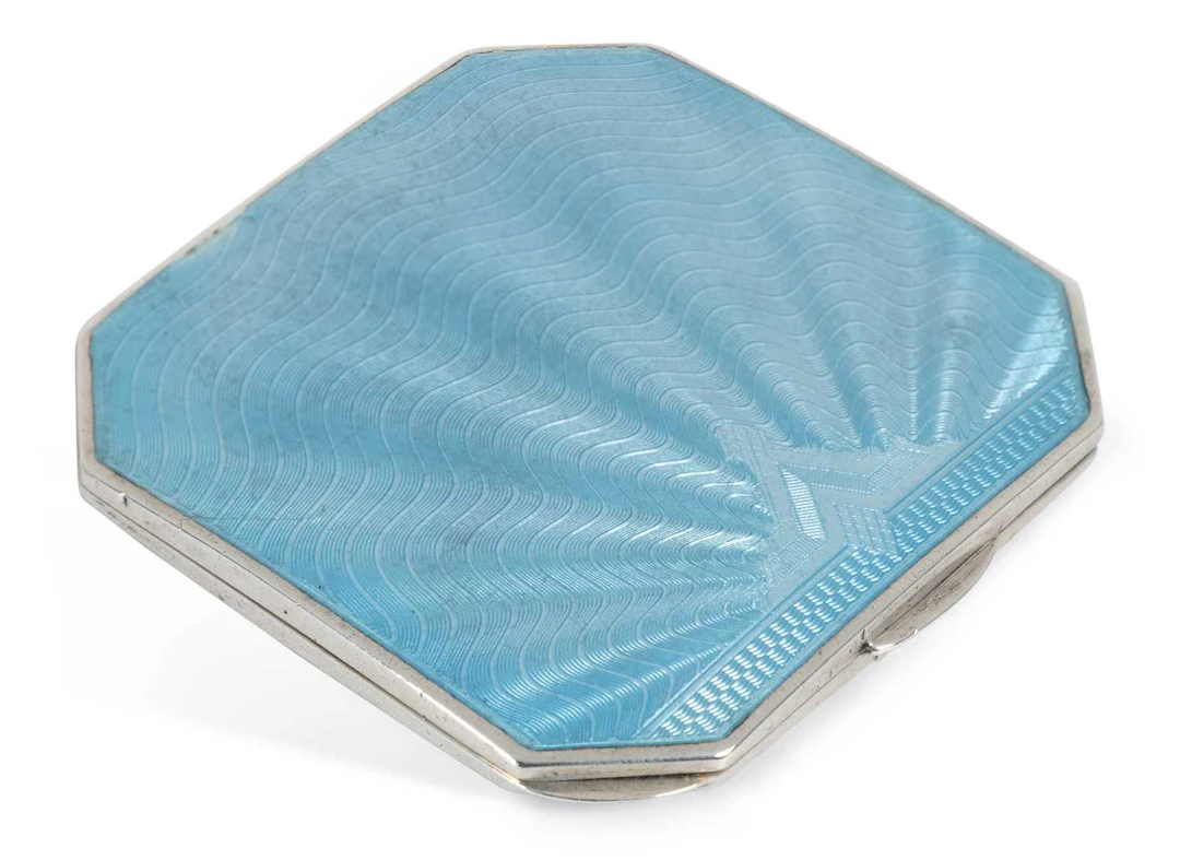 AN ART DECO SILVER AND ENAMEL COMPACT