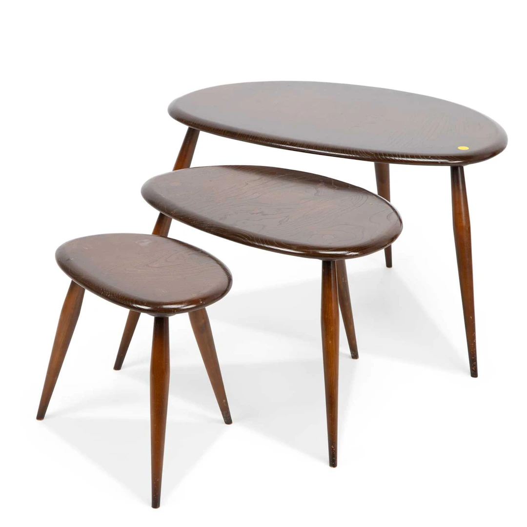 AN ERCOL NEST OF THREE PEBBLE TABLES
