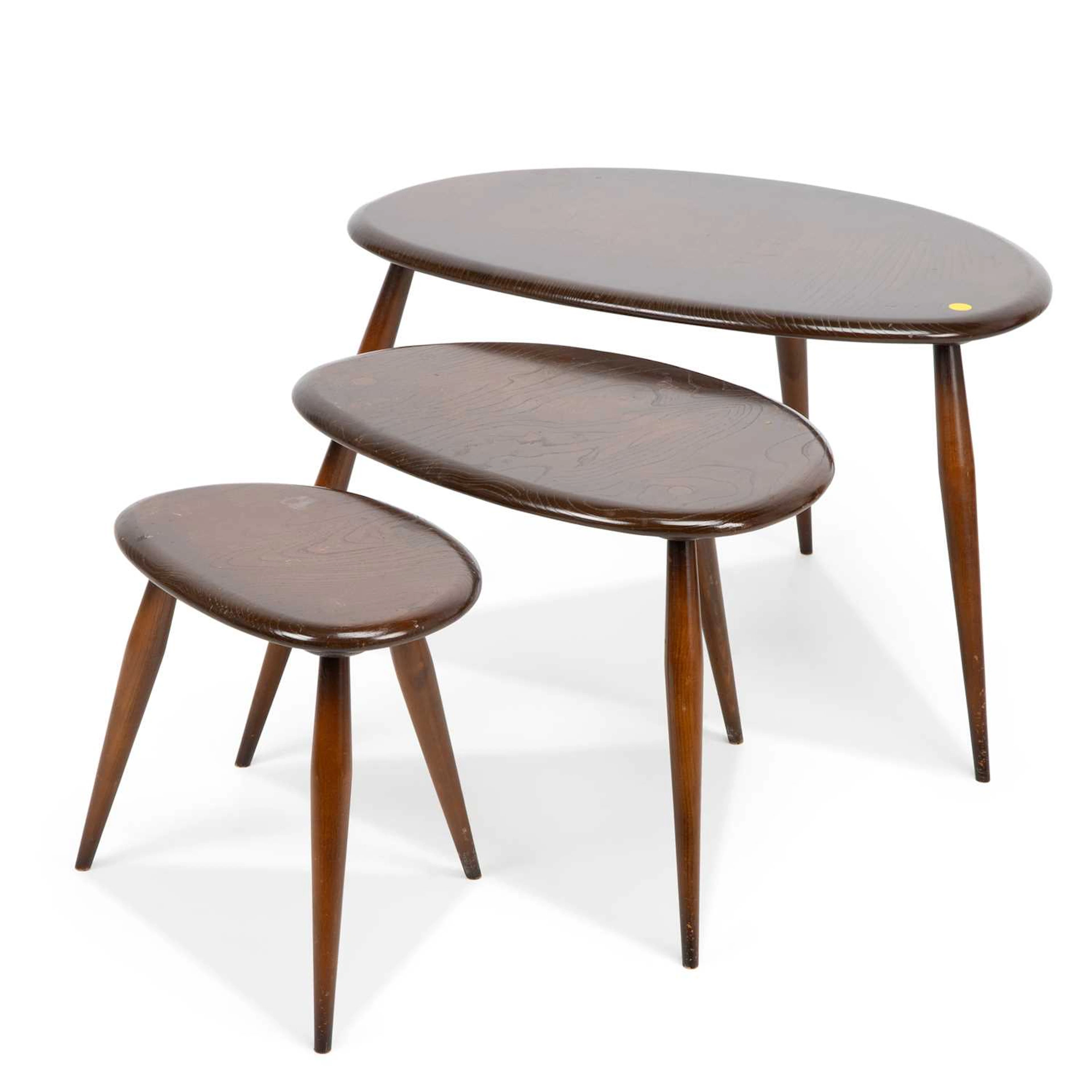 AN ERCOL NEST OF THREE PEBBLE TABLES