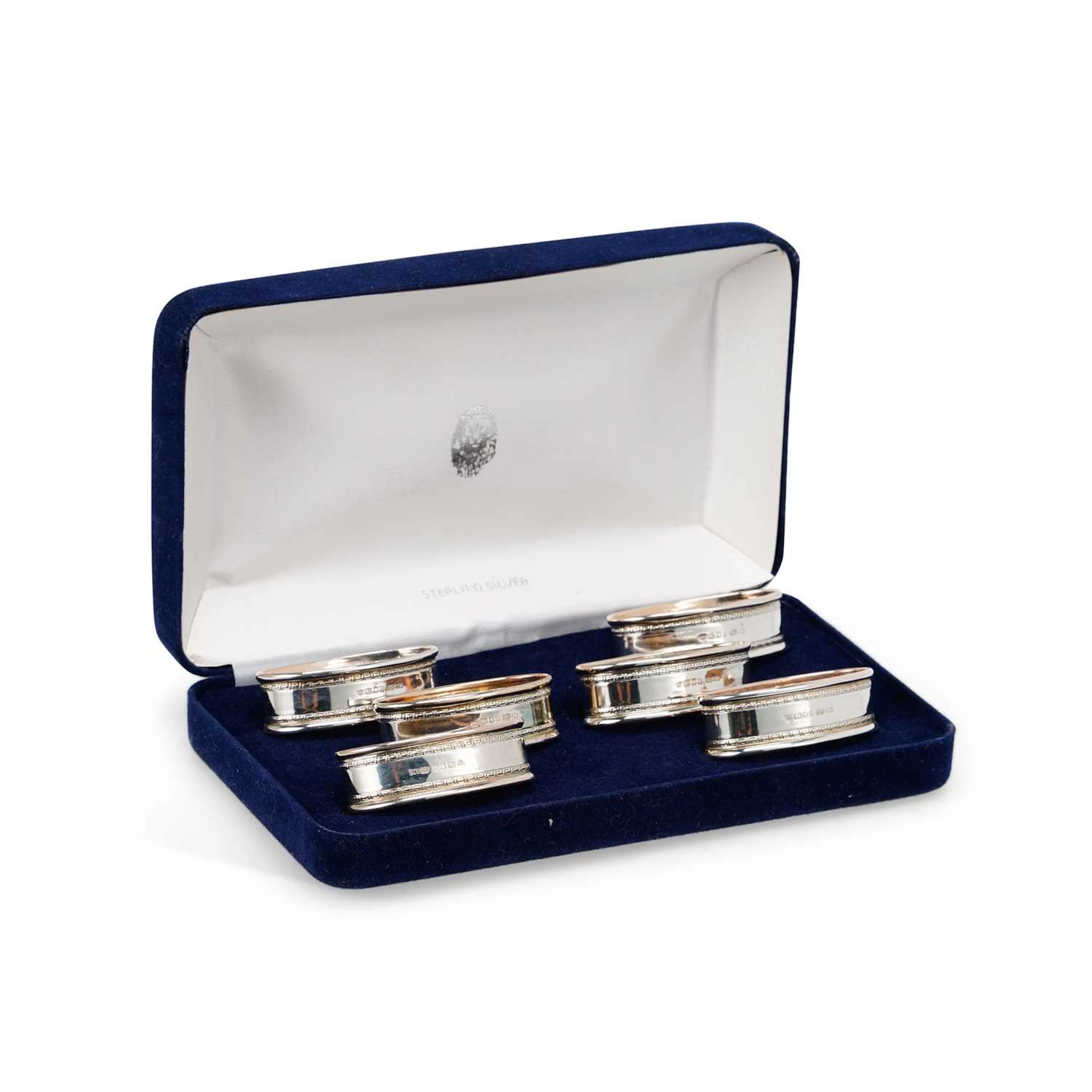 AN ELIZABETH II CASED SET OF SIX SILVER NAPKIN RINGS