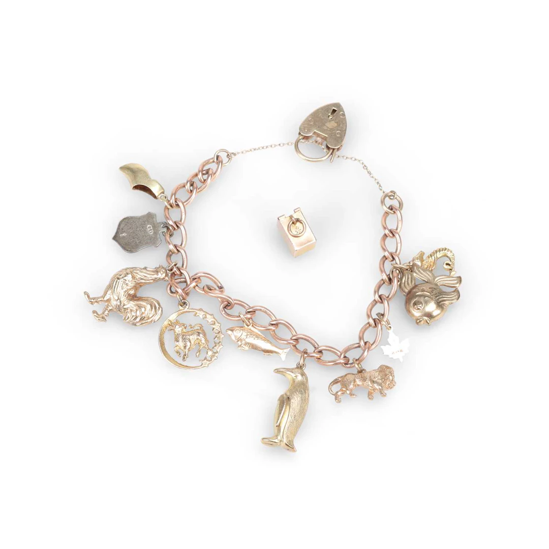A 9 CARAT GOLD CHARM BRACELET