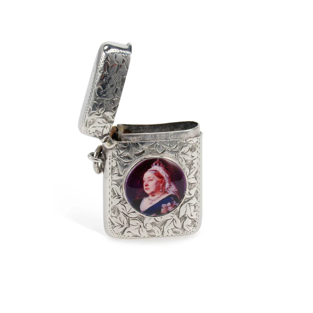 AN EDWARDIAN SILVER AND ENAMEL VESTA CASE