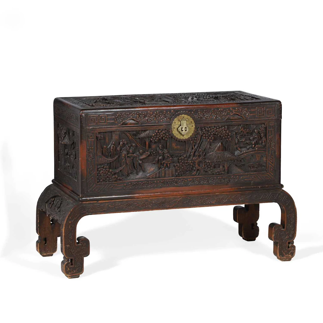 A CHINESE CARVED CAMPHORWOOD CHEST ON STAND