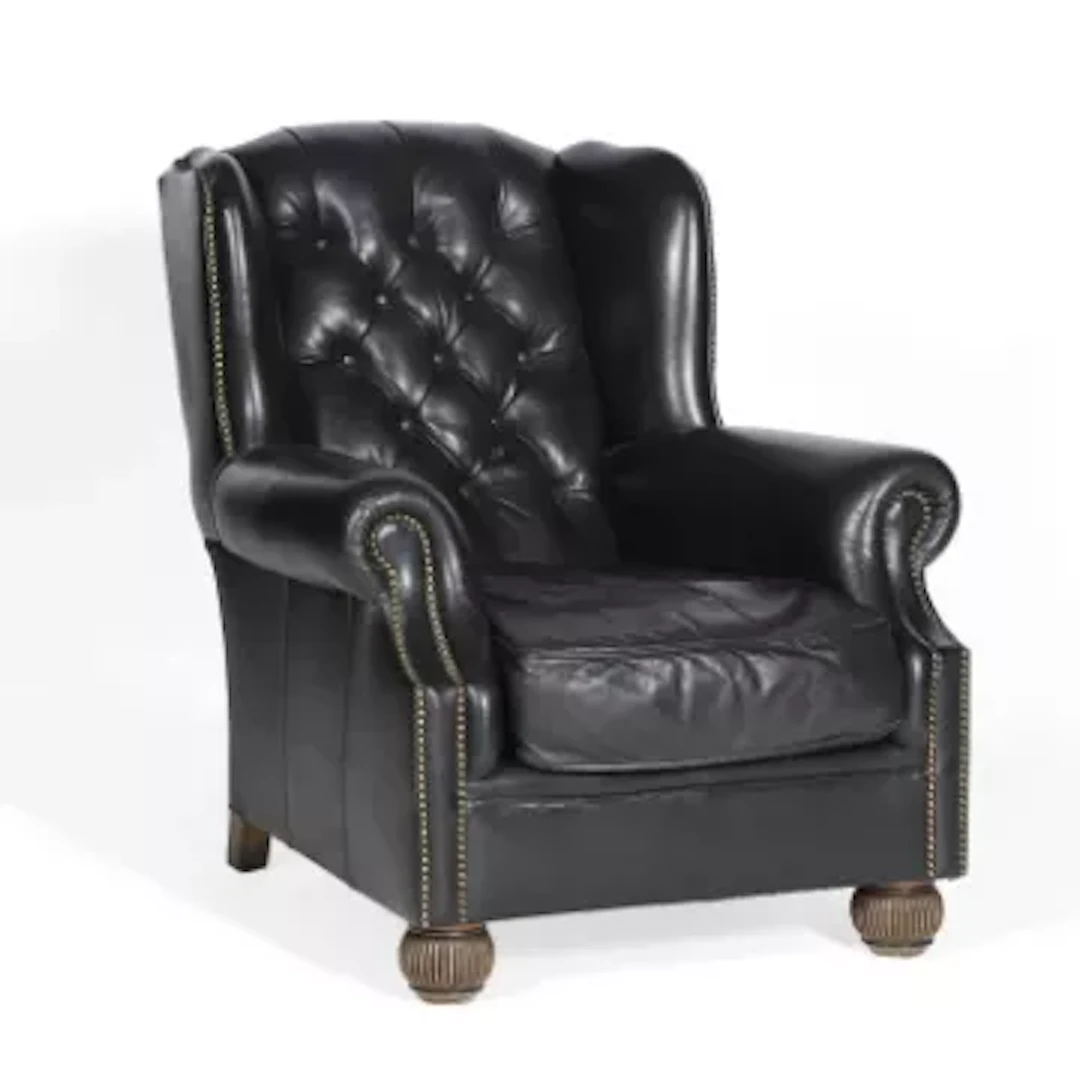 A TETRAD BLACK LEATHER WING ARMCHAIR