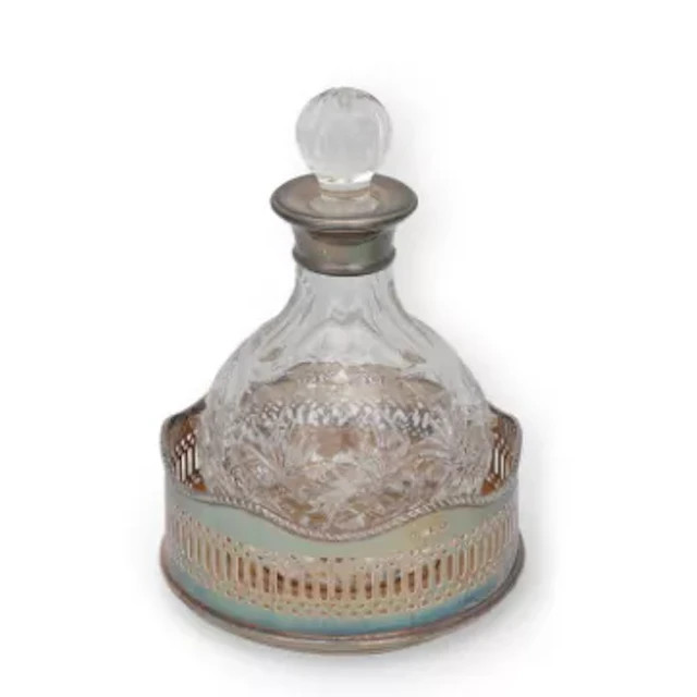A SILVER-MOUNTED GLASS DECANTER AND A SILVER WINE COASTER
